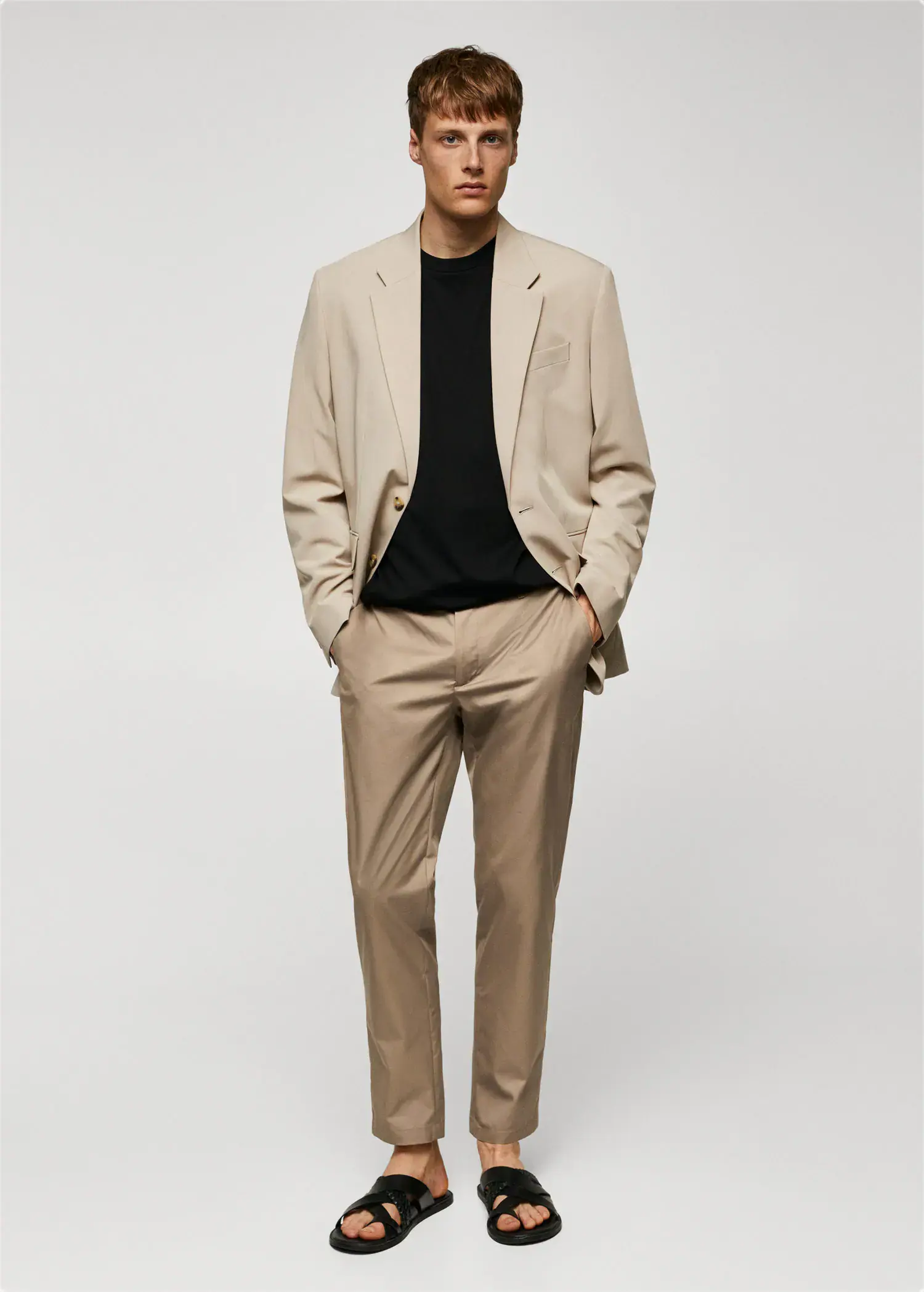 Mango Slim-fit cotton trousers. a man wearing a suit and a black shirt. 