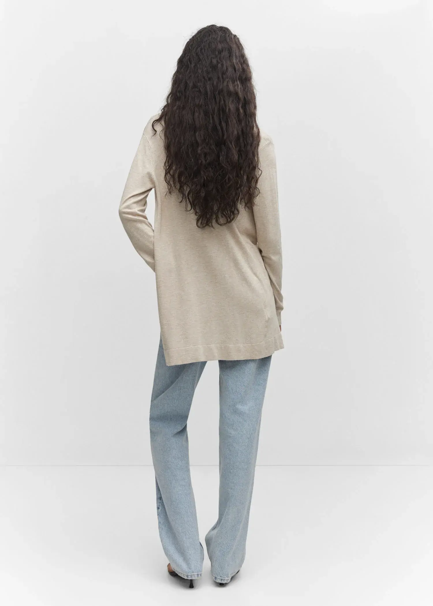 Mango Fine-knit cardigan. a woman standing in front of a white wall. 