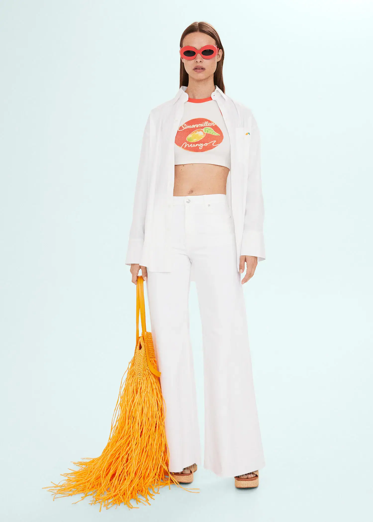 Mango High-rise wideleg jeans . a woman in a white outfit holding a yellow bag. 