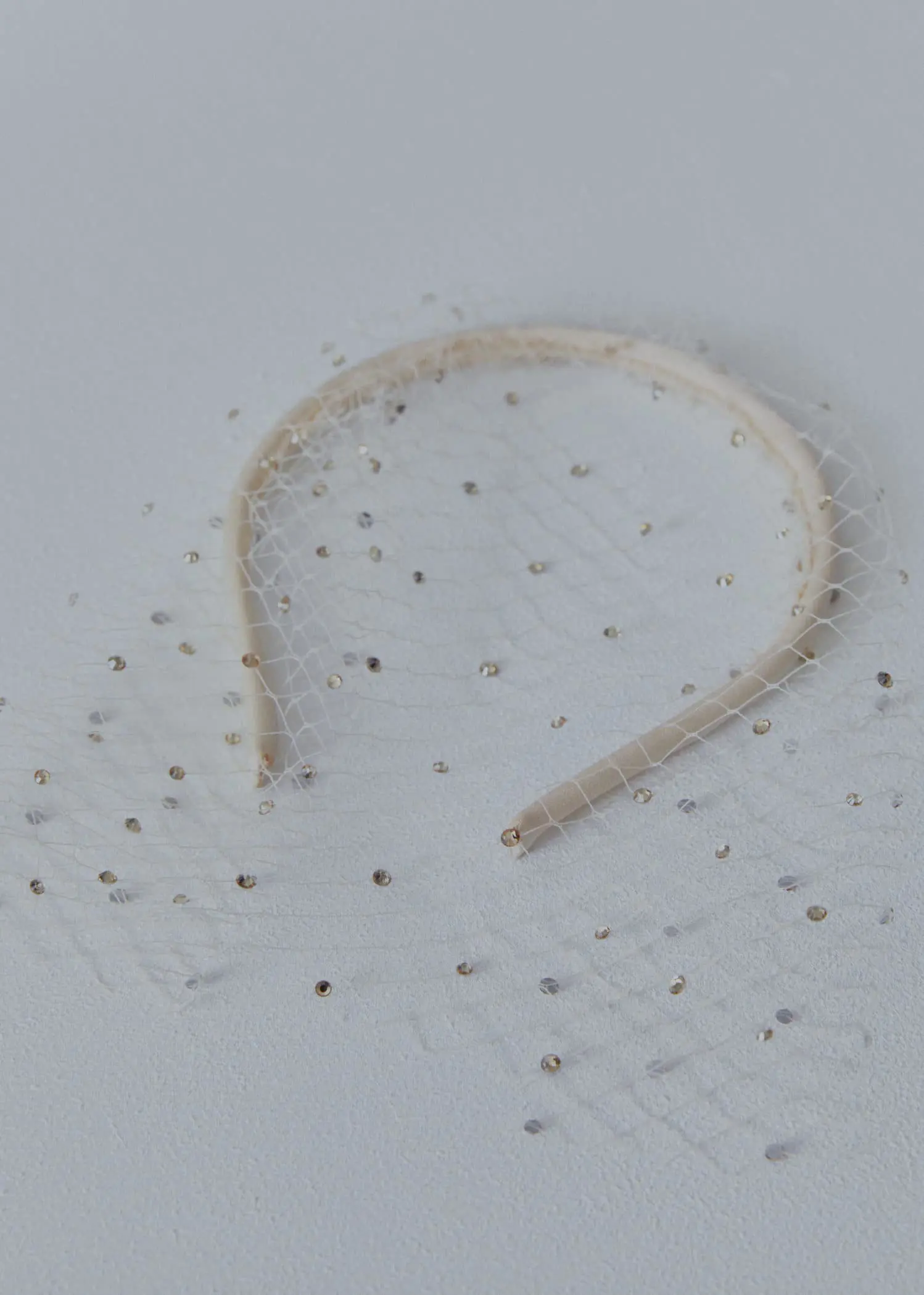 Mango Rhinestone mesh headband. a close-up of a hairband on a white surface. 