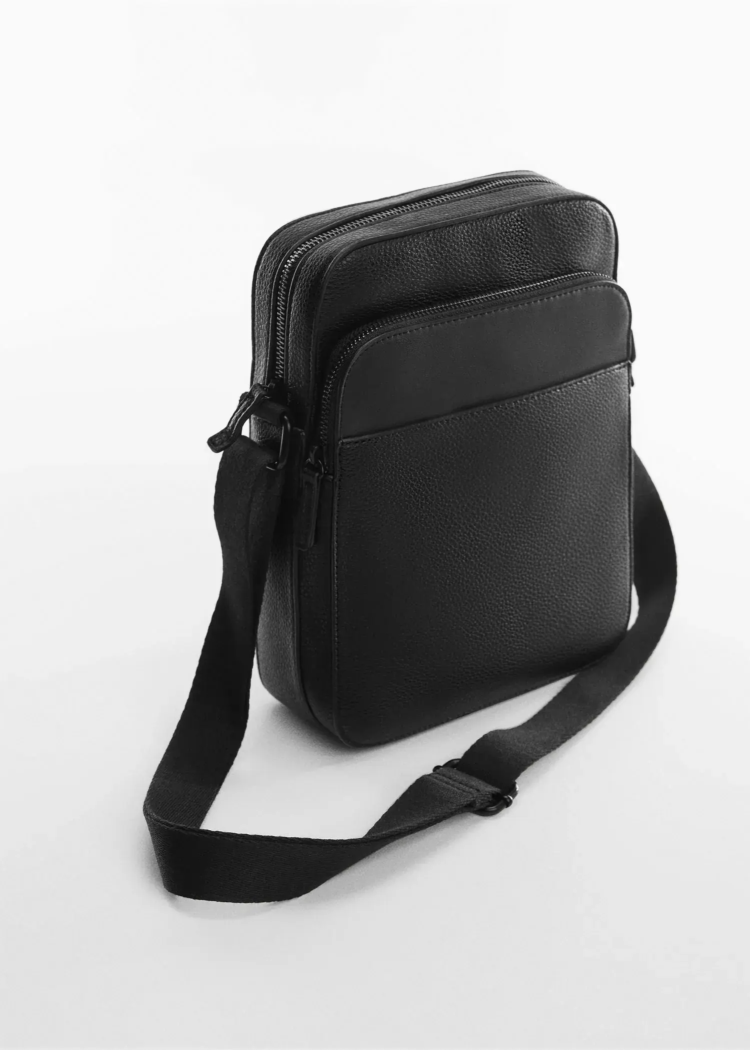 Mango Leather-effect shoulder bag. a black bag is sitting on the ground 