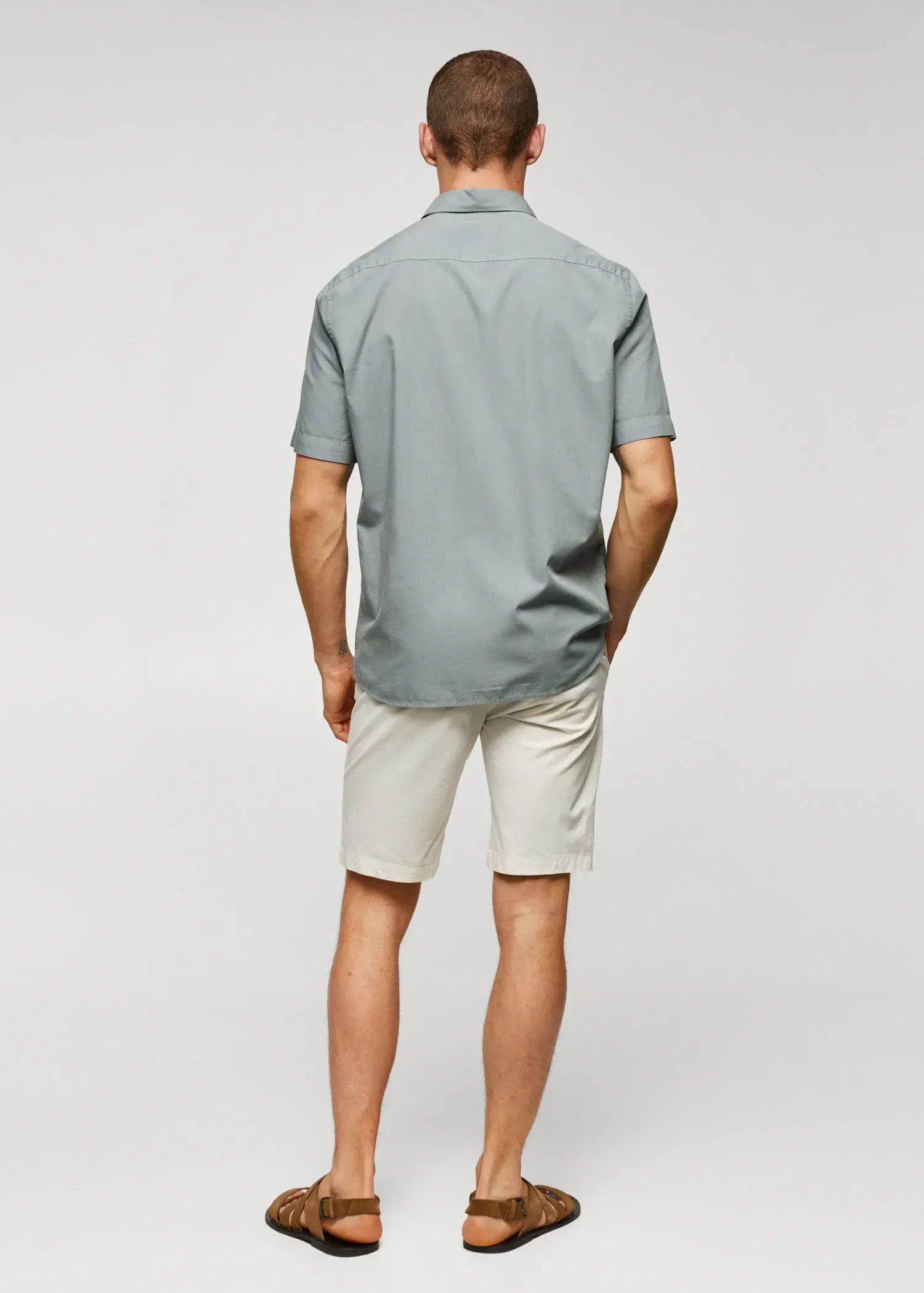 Mango Lightweight cotton shirt . a man wearing a gray shirt and white shorts. 