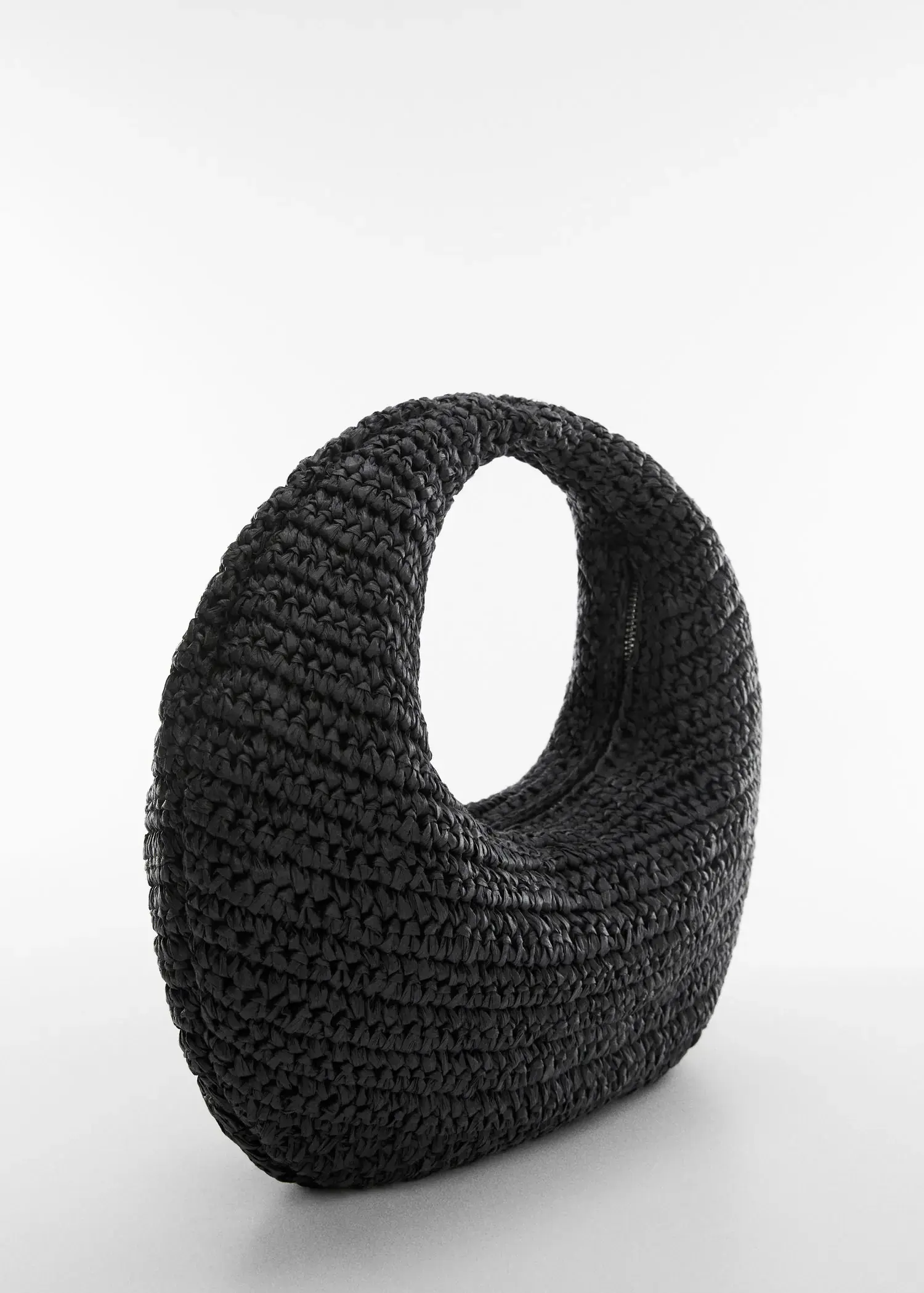 Mango Round natural fiber bag. a close-up of a black crocheted bag. 