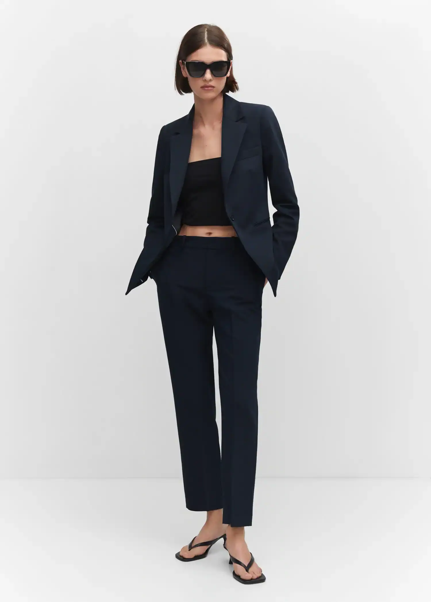 Mango Straight suit trousers. a woman in a black suit is posing for a picture 