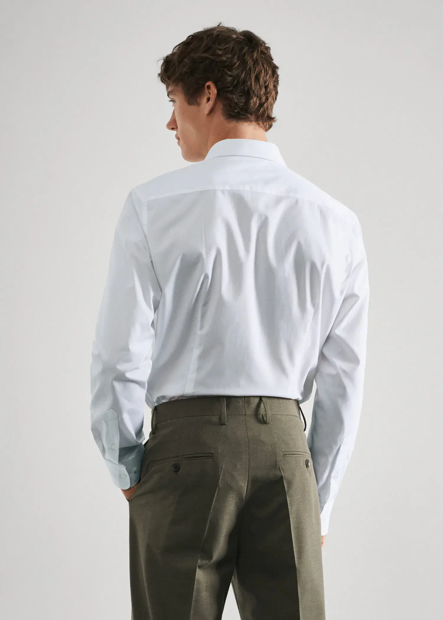 Mango Slim-fit cotton poplin suit shirt. a man in a white shirt and green pants. 