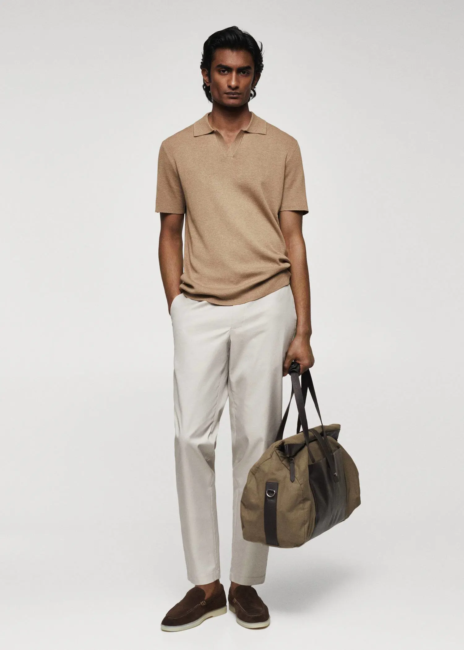 Mango Fine-knit polo shirt. a man in a tan polo shirt holding a bag. 