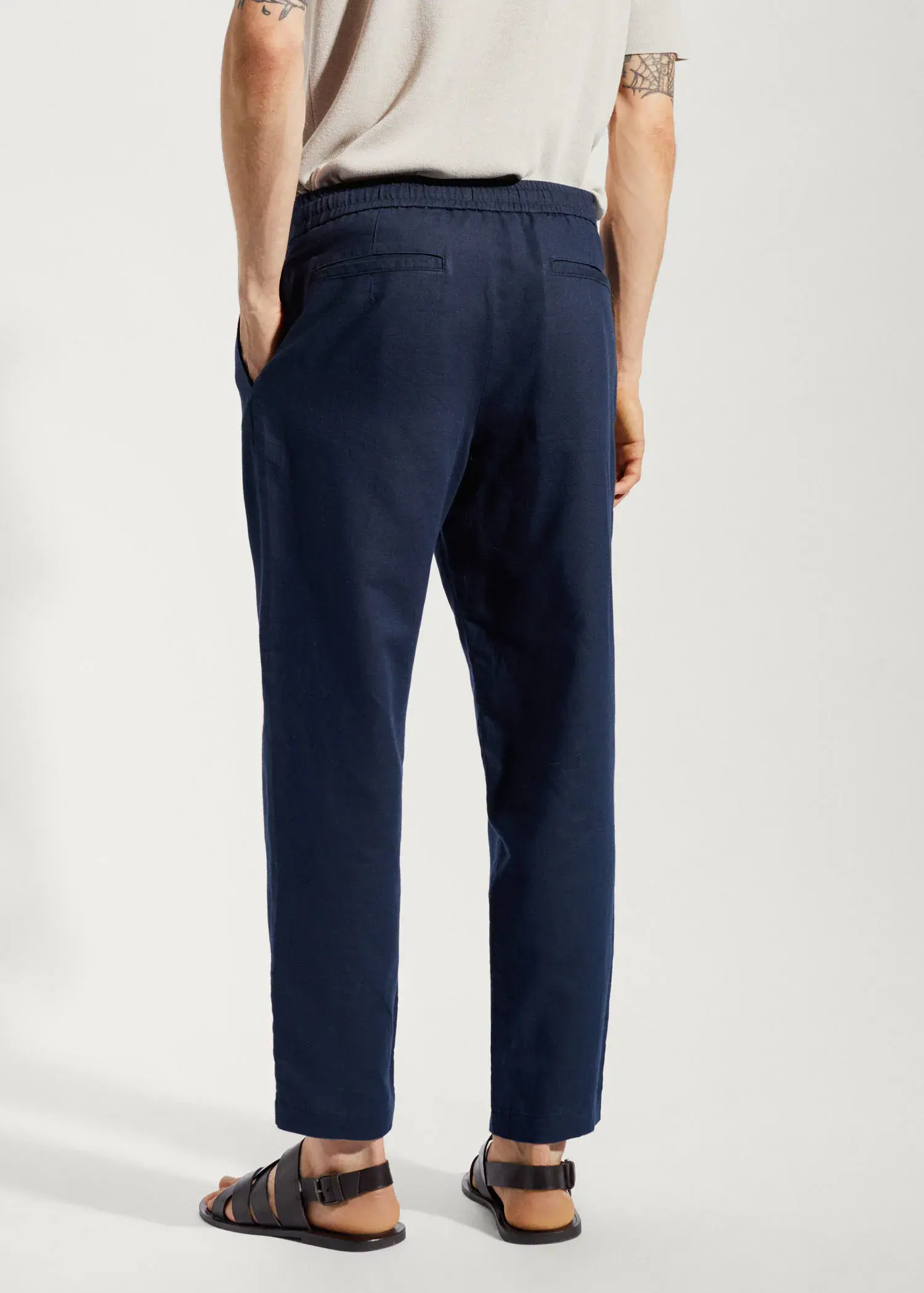 Mango Slim-fit trousers with drawstring . a person wearing a pair of navy blue pants. 