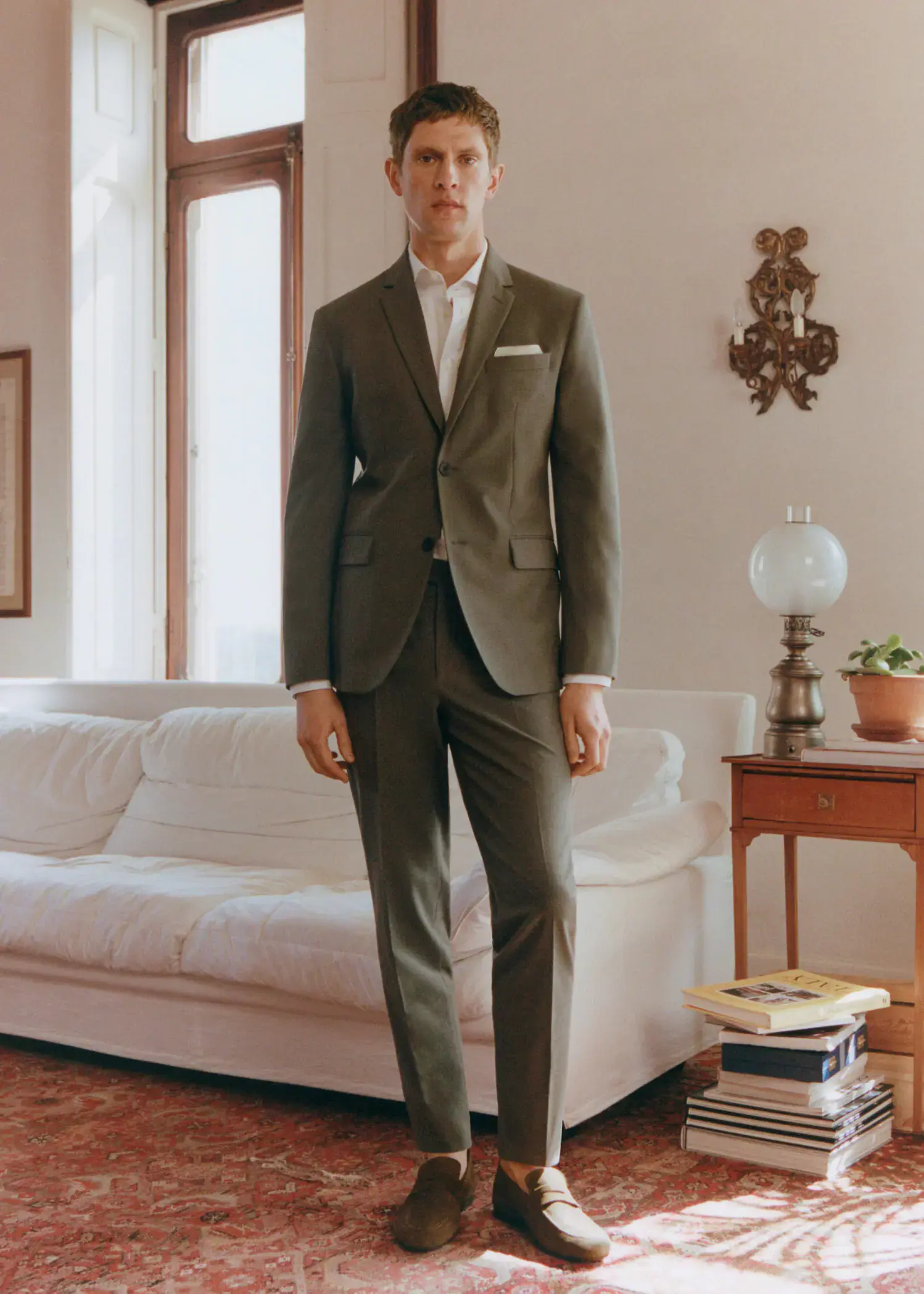 Mango Stretch fabric slim-fit suit pants. a man in a suit standing in a living room. 