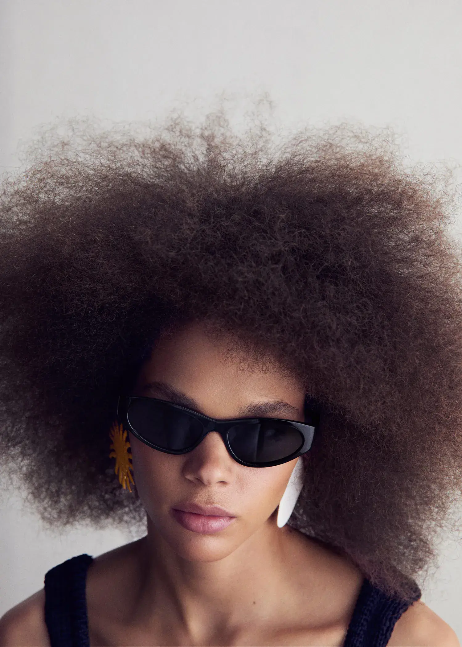 Mango Retro style sunglasses. a close up of a person wearing sunglasses 