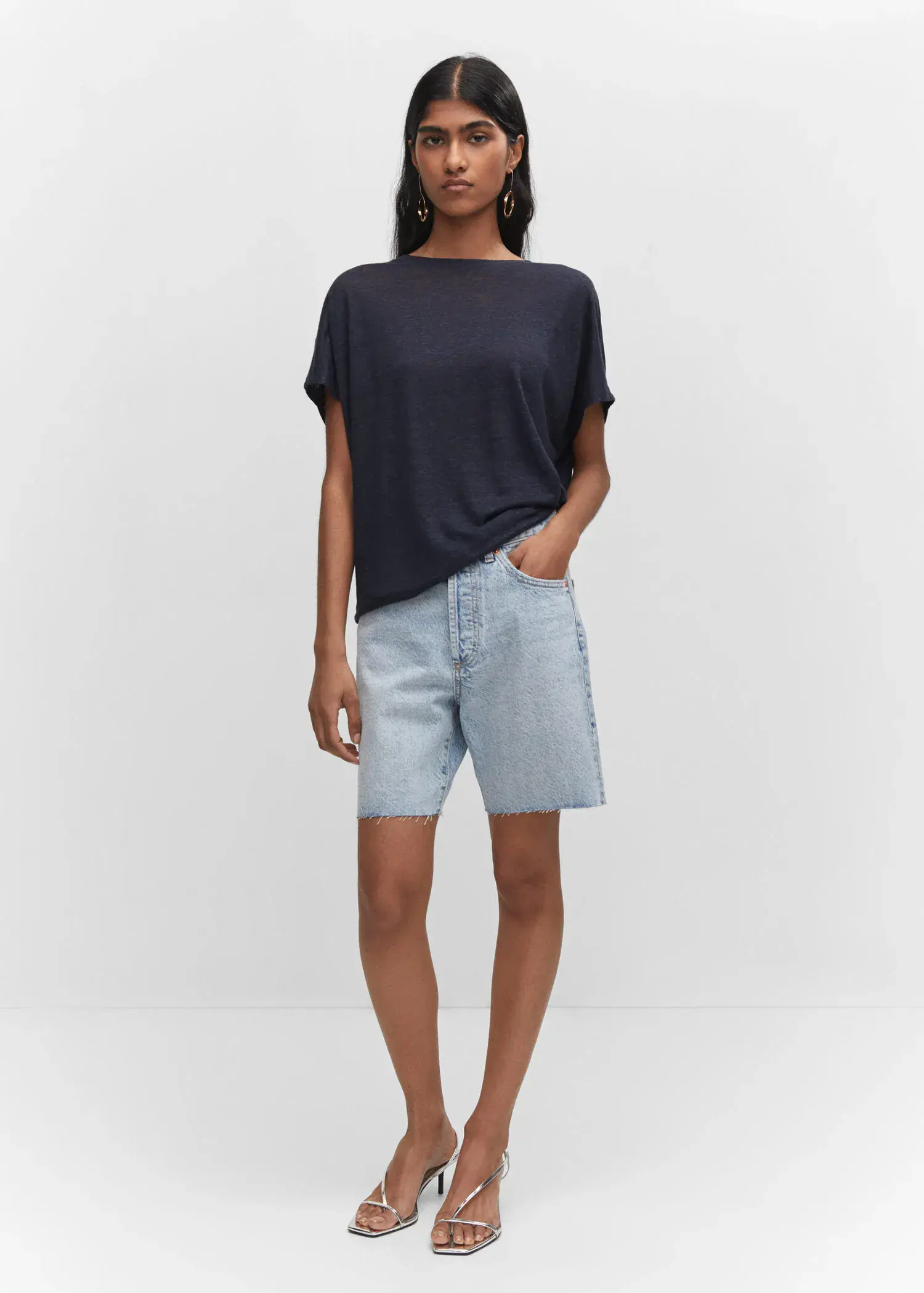 Mango Oversized linen t-shirt. a woman wearing a pair of light blue denim shorts. 