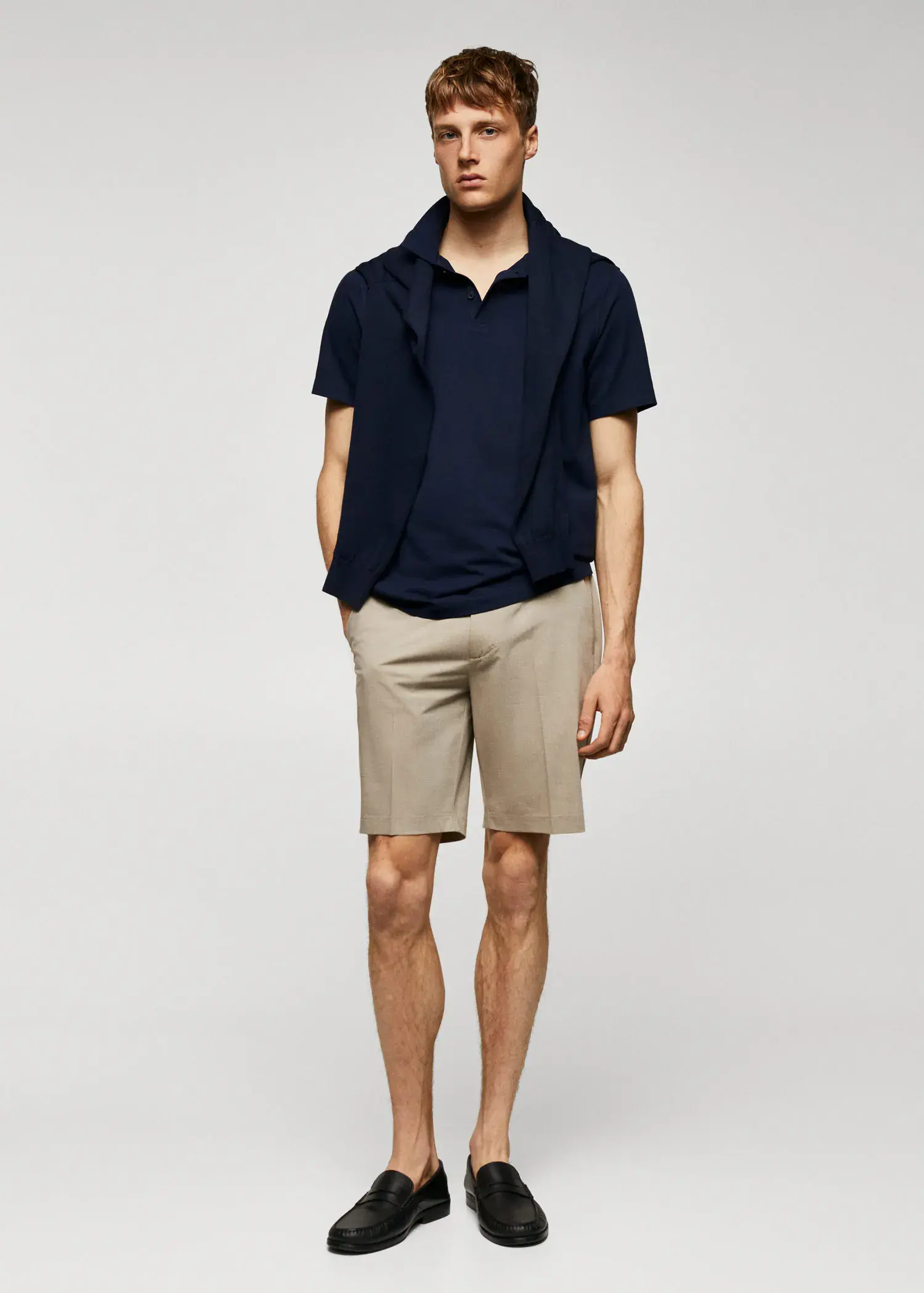 Mango Slim-fit textured cotton polo shirt. a young man in shorts and a black shirt. 
