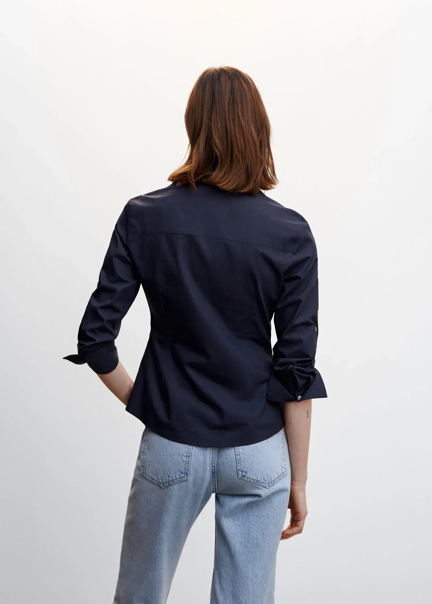 Mango Pleated cotton shirt. a woman wearing a black shirt and jeans. 