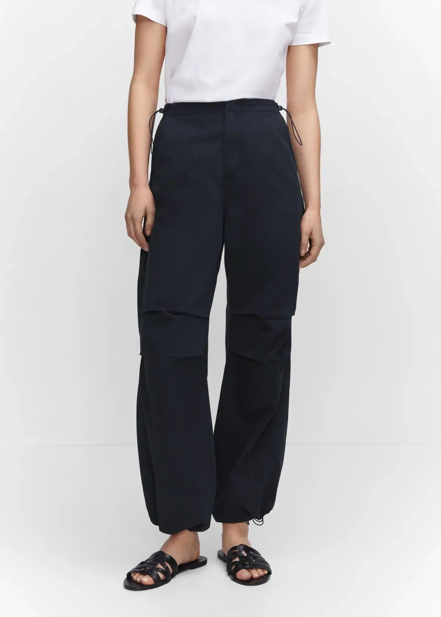 Mango Parachute trousers. a person standing wearing a pair of black pants. 