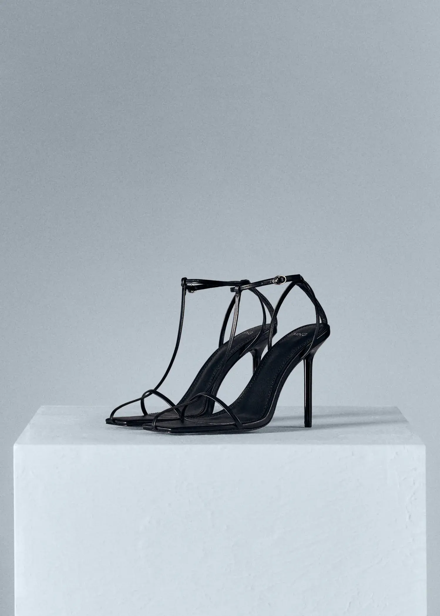 Mango Straps heel leather sandals. a pair of black high heel shoes sitting on top of a box. 