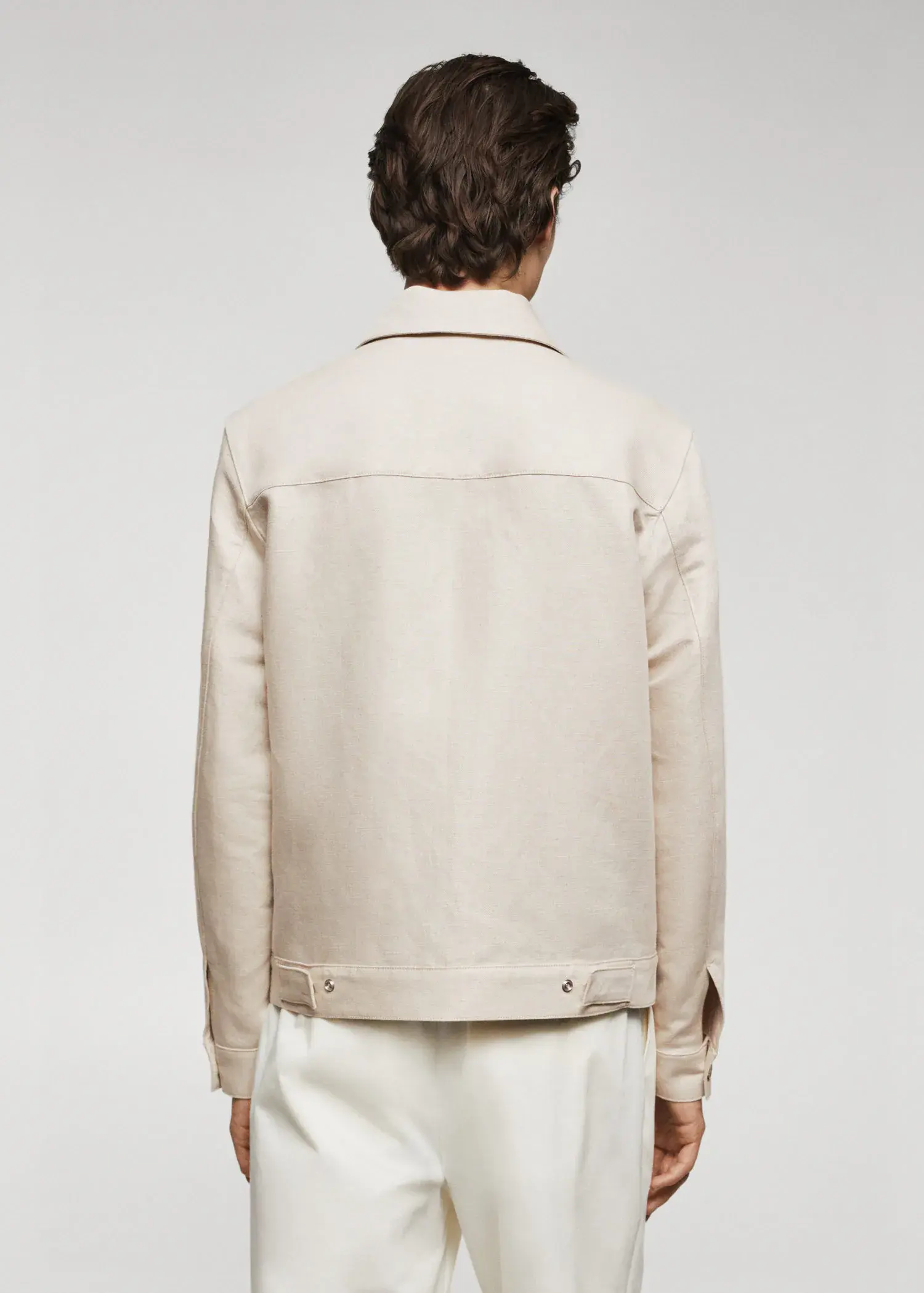 Mango Pocket linen-blend jacket. a person wearing a white jacket standing next to a wall. 