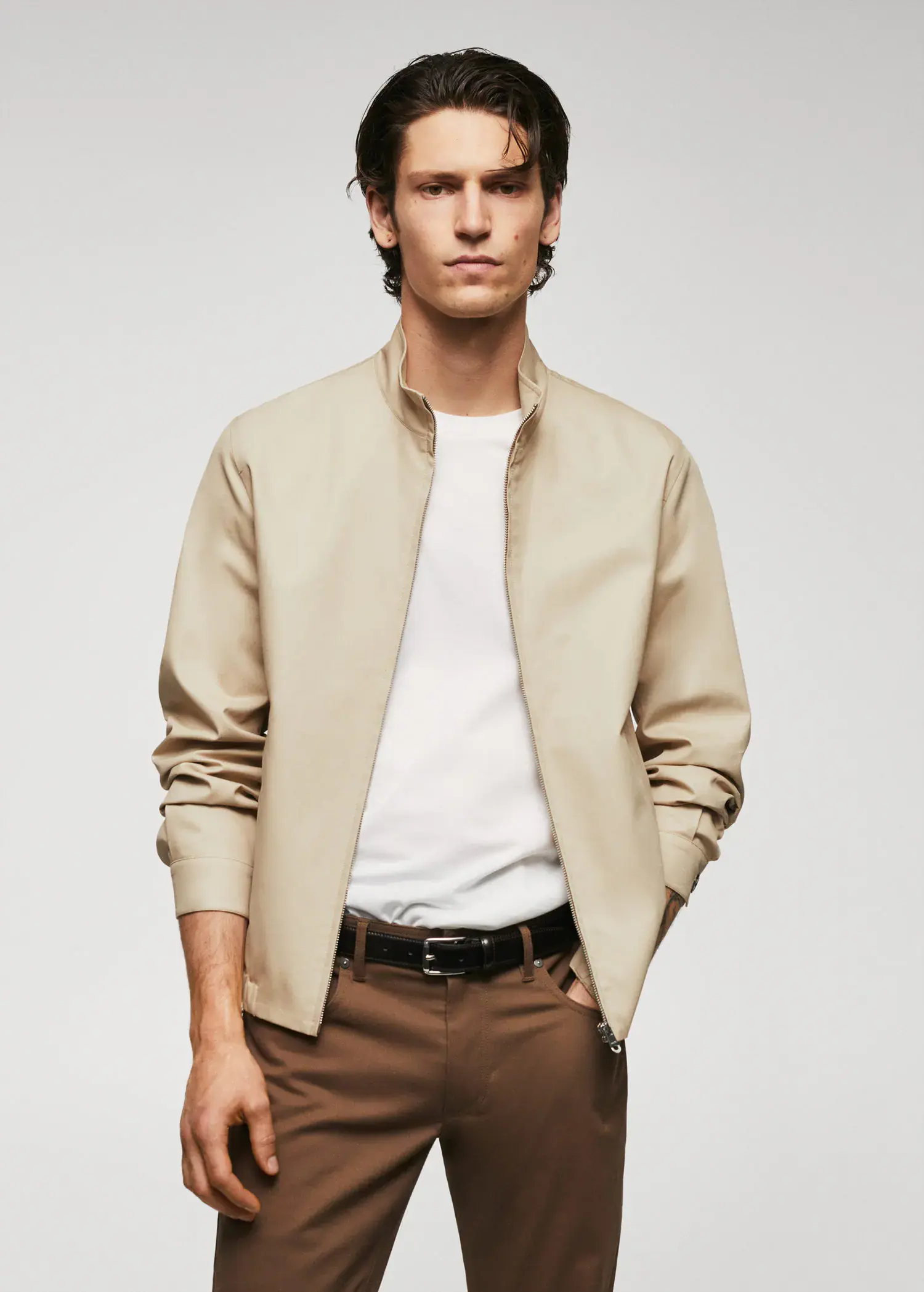 Mango 100% cotton bomber jacket. a man in a tan jacket and brown pants. 