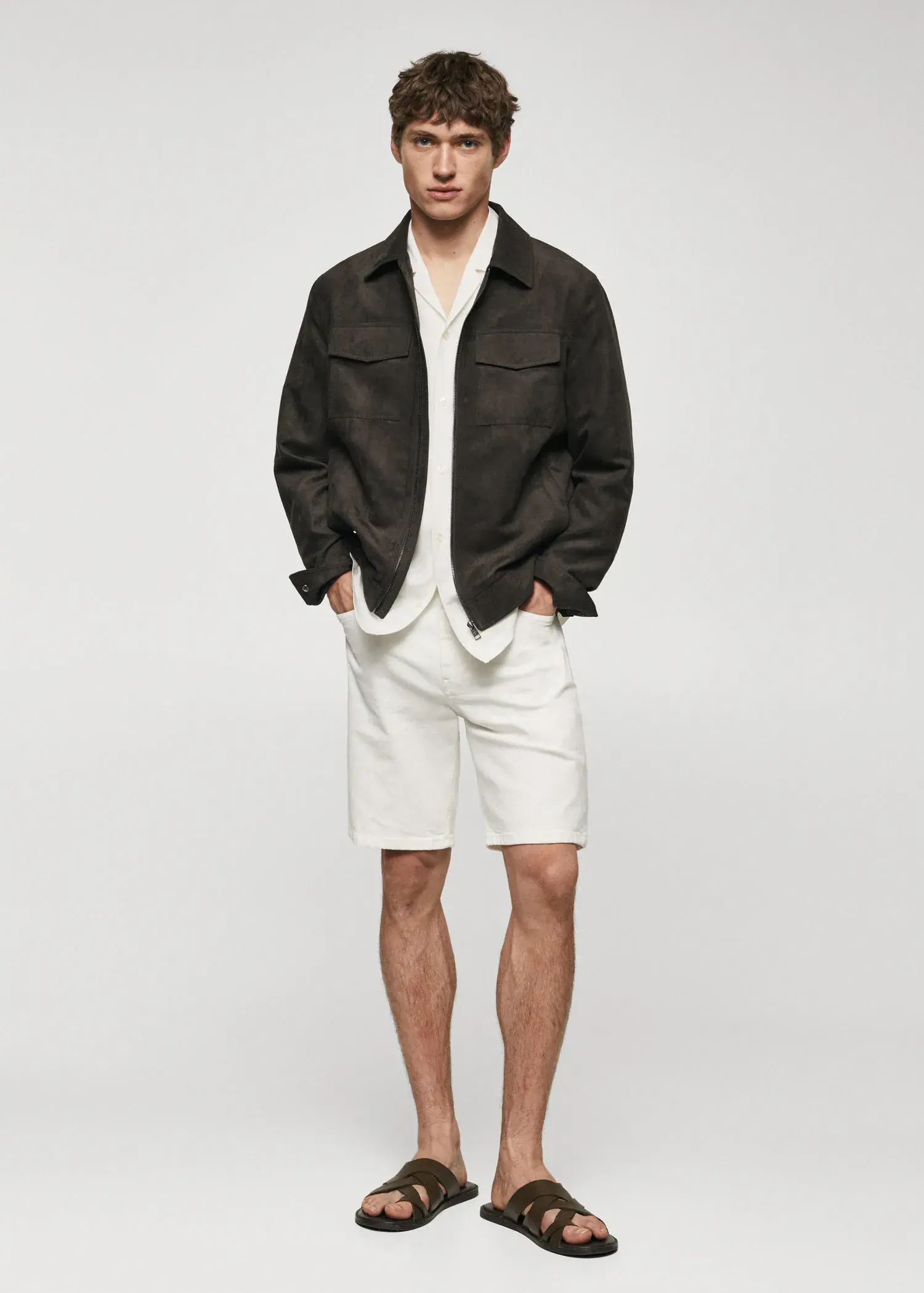Mango Suede effect jacket. a man wearing a black jacket and white shorts. 