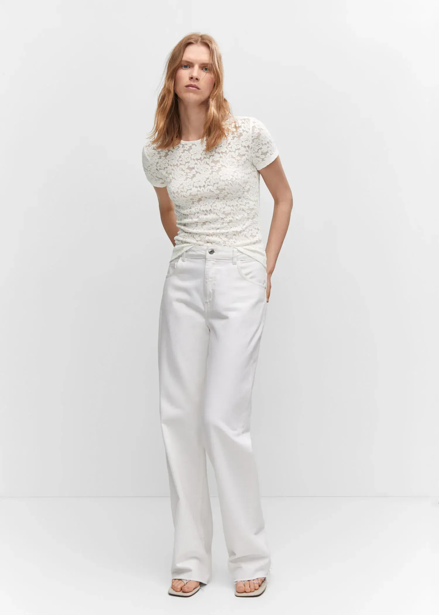 Mango Guipure T-shirt. a woman wearing white pants and a white top. 