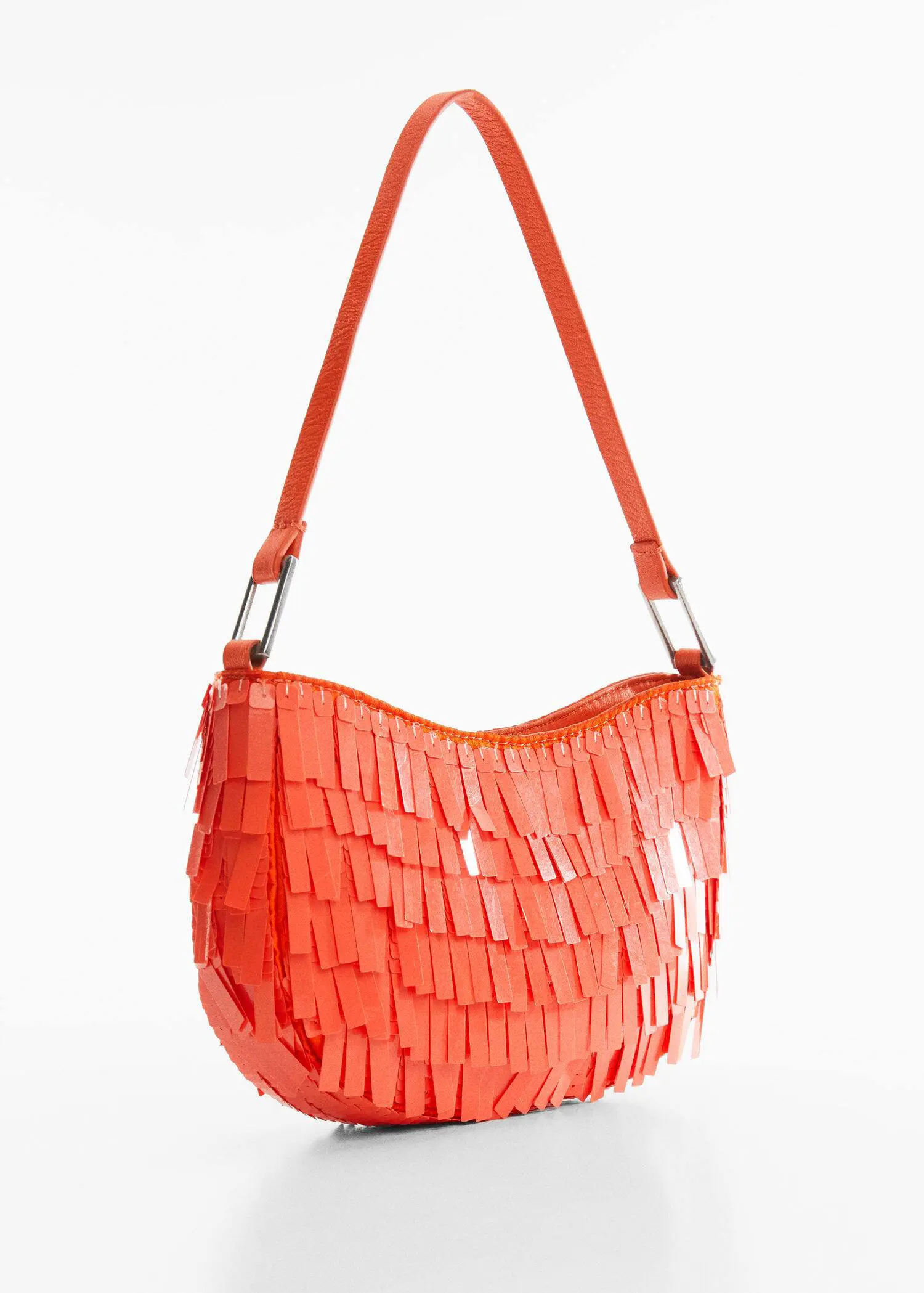Mango Fringed shoulder bag. a bright orange purse is hanging on a white wall. 