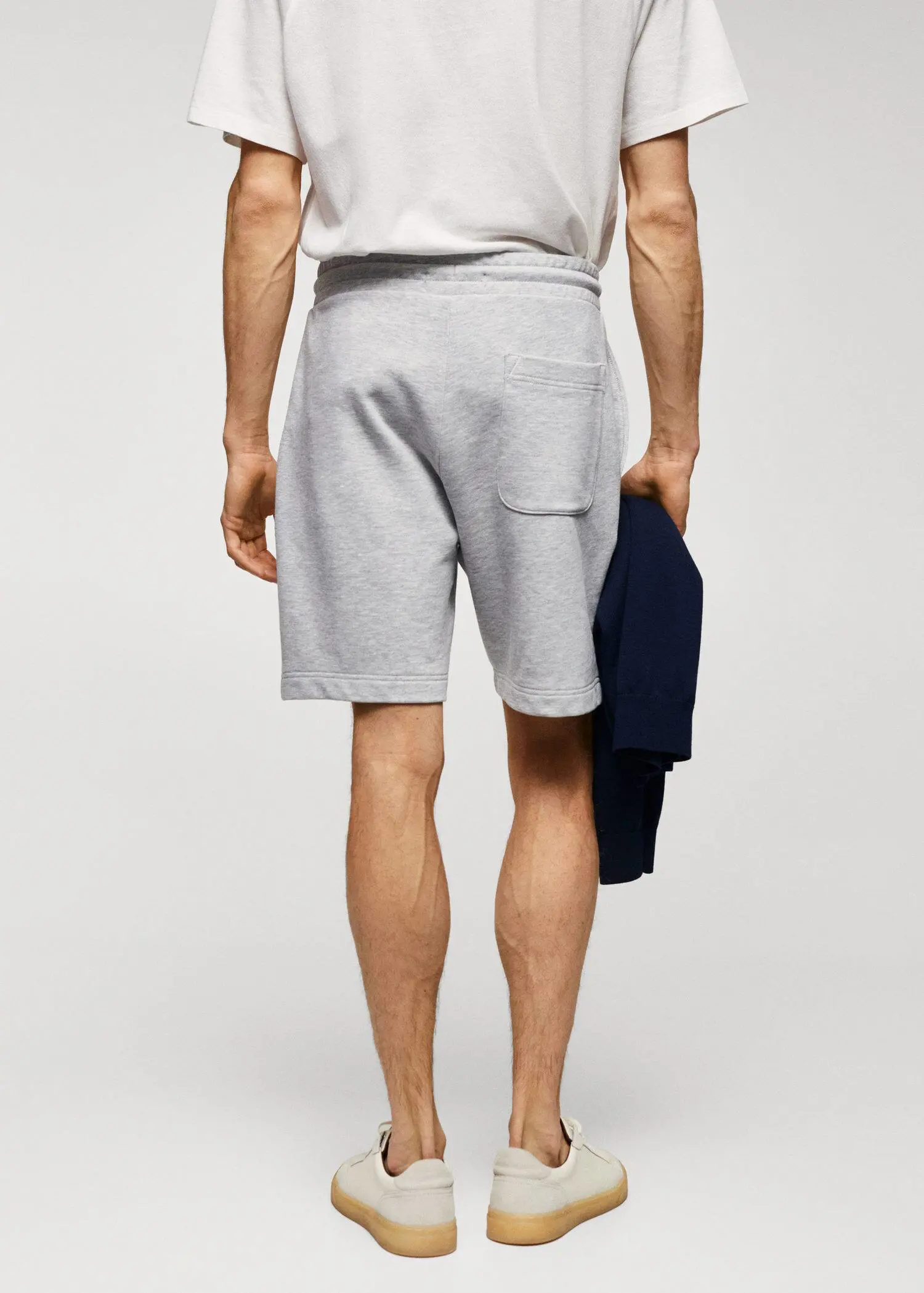 Mango Jogger cotton Bermuda shorts. a man is holding a towel in his hand. 