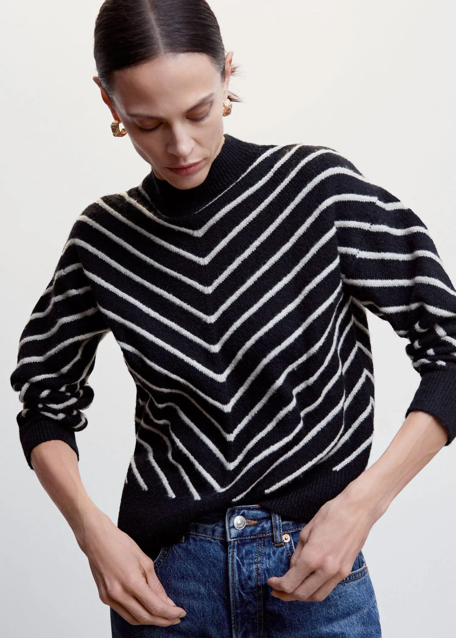Mango Stripe-print sweater with Perkins neck. a woman wearing a black and white striped sweater. 