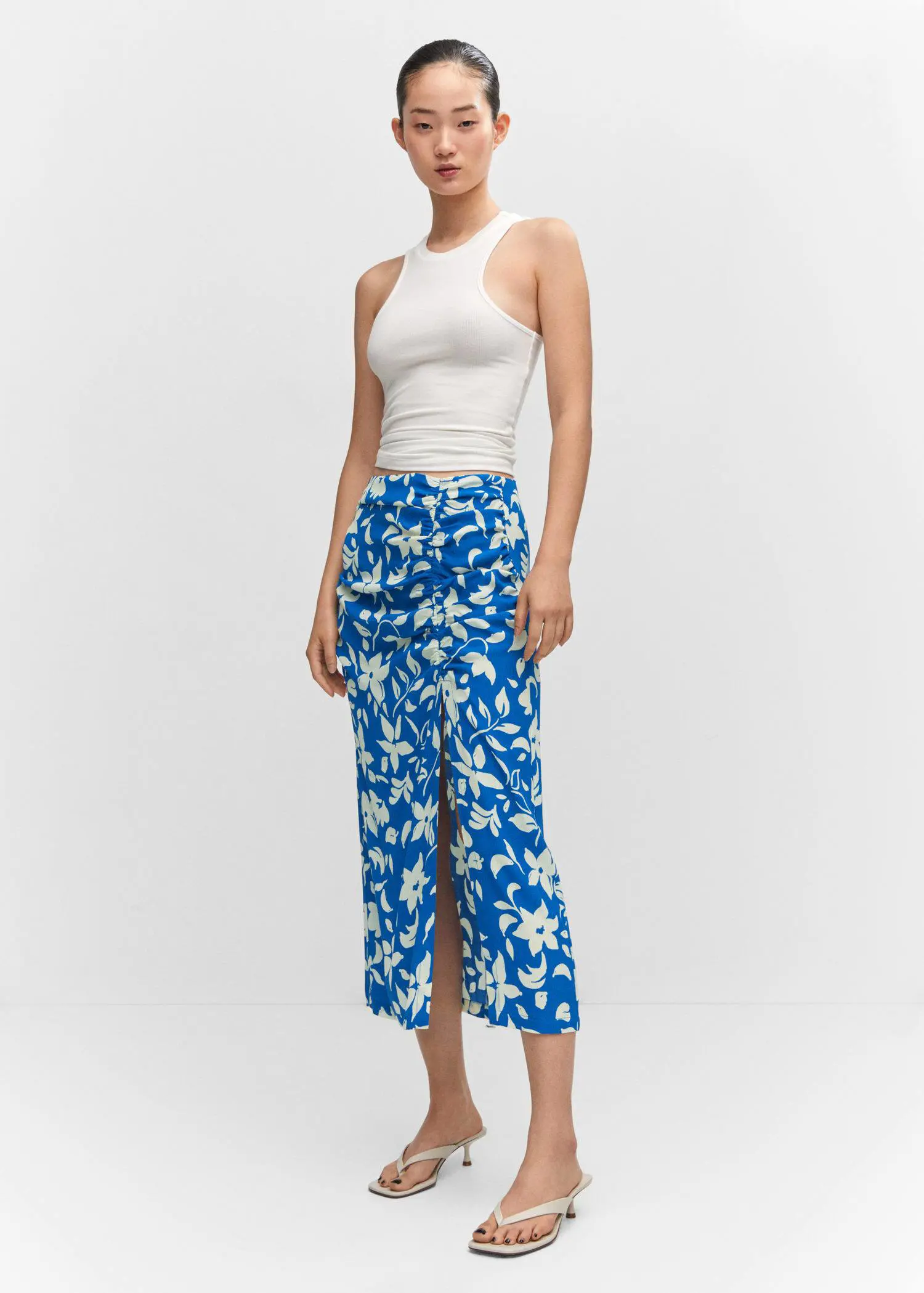 Mango Printed skirt with slit. a woman wearing a white top and blue skirt. 
