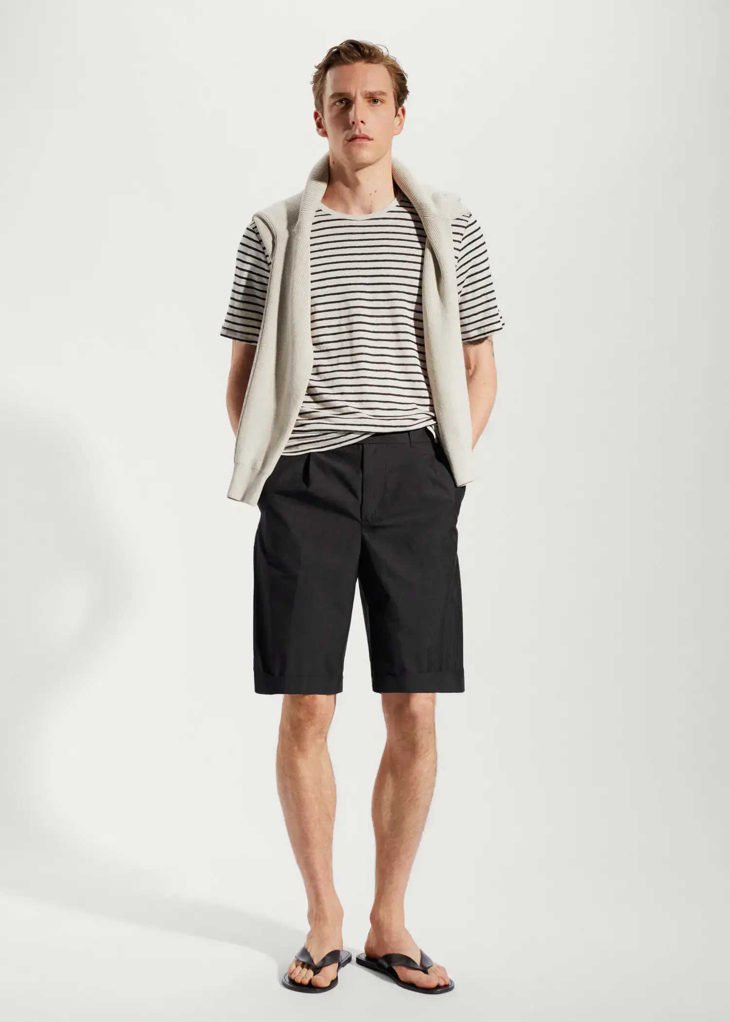 Mango 100% linen striped t-shirt. a young man wearing a striped shirt and shorts. 