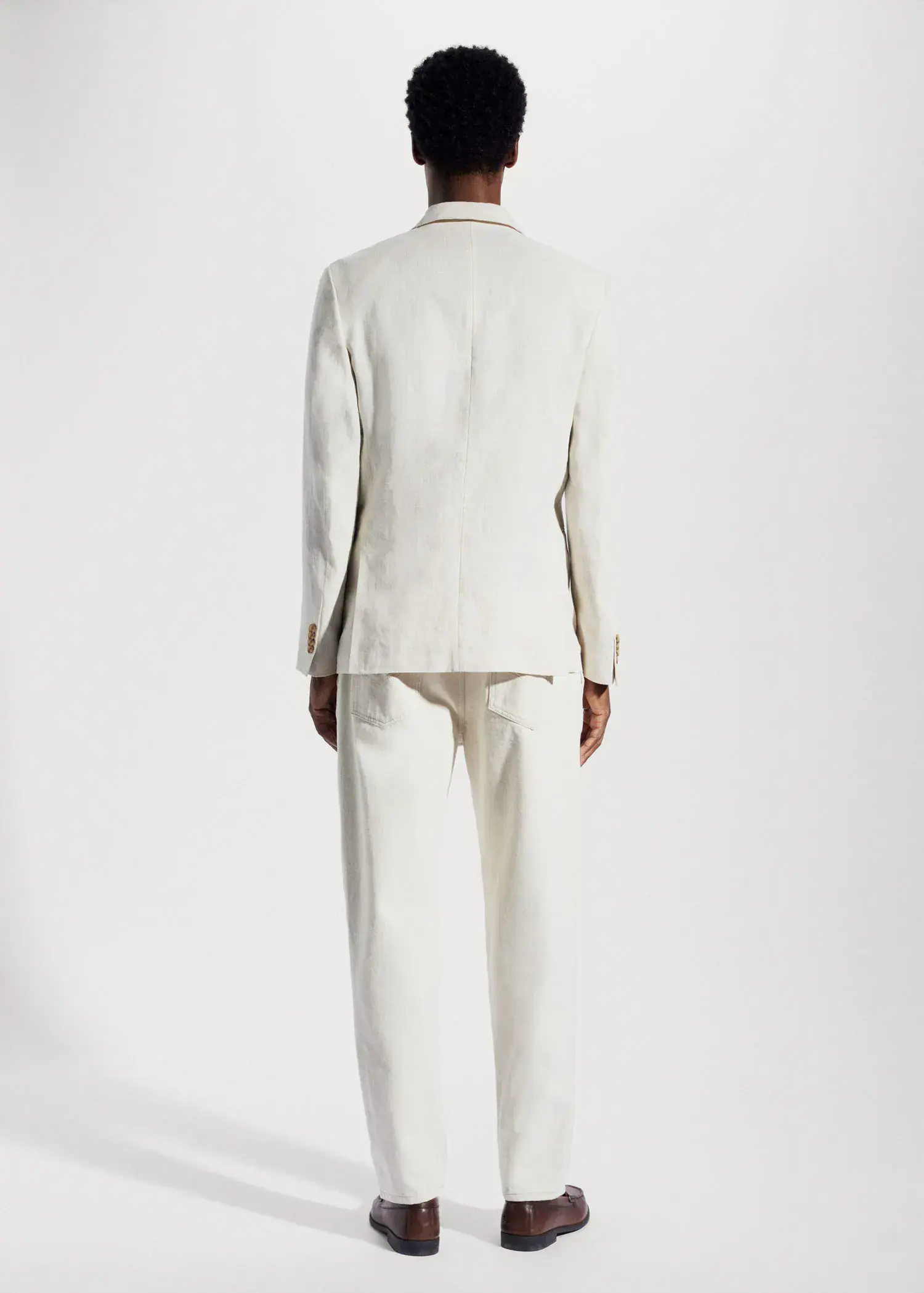 Mango 100% linen slim fit blazer. a man in a white suit standing in front of a white wall. 
