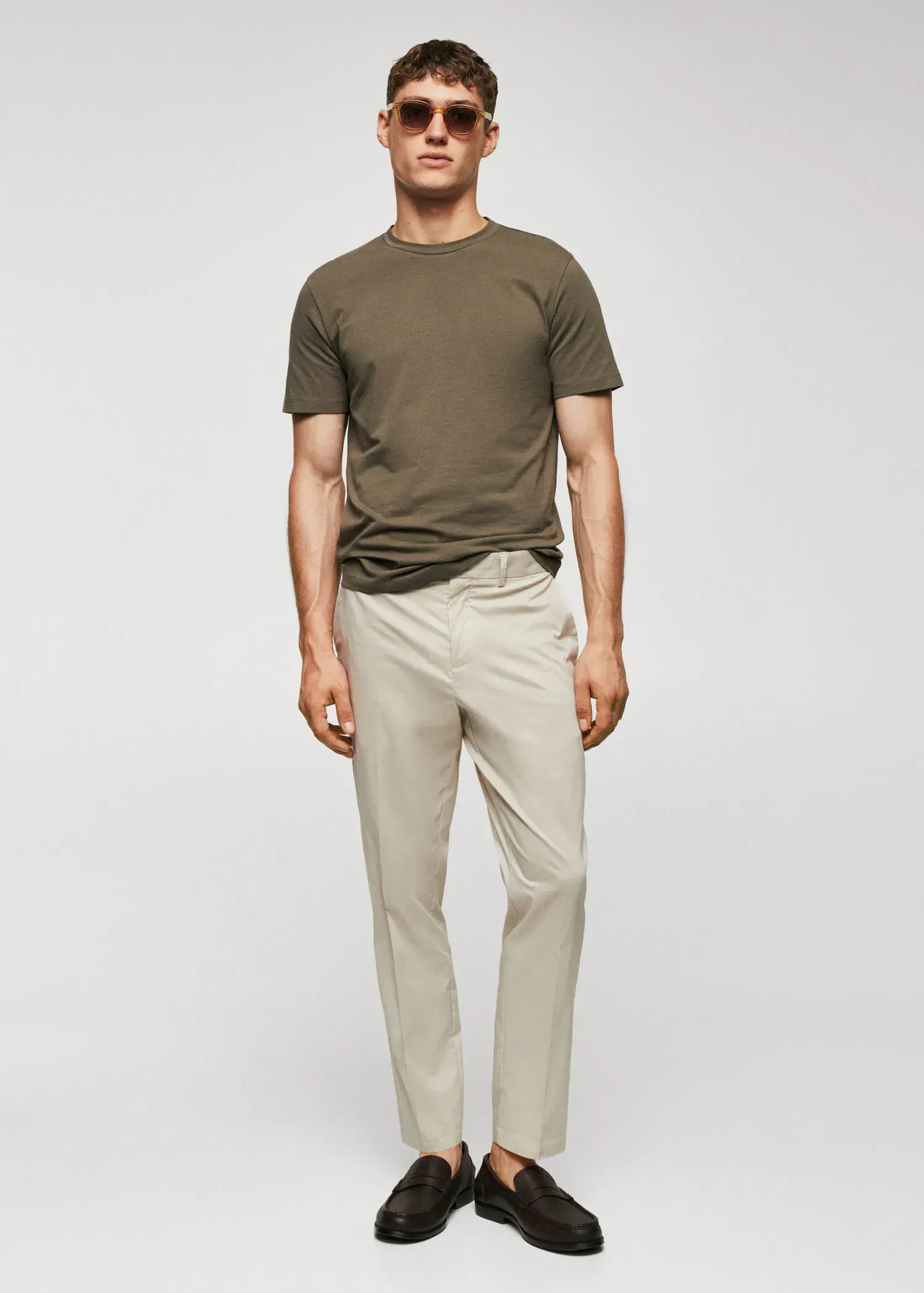 Mango Stretch cotton T-shirt. a man in a brown shirt and beige pants. 