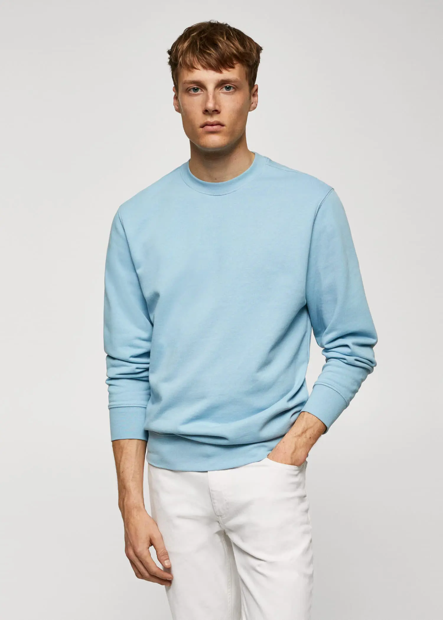 Mango 100% cotton basic sweatshirt . a man wearing a light blue sweatshirt and white pants. 