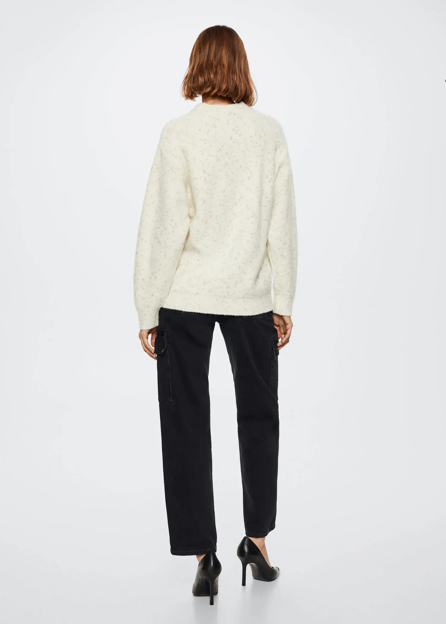 Mango Textured round neck sweater. a person standing in front of a white wall. 