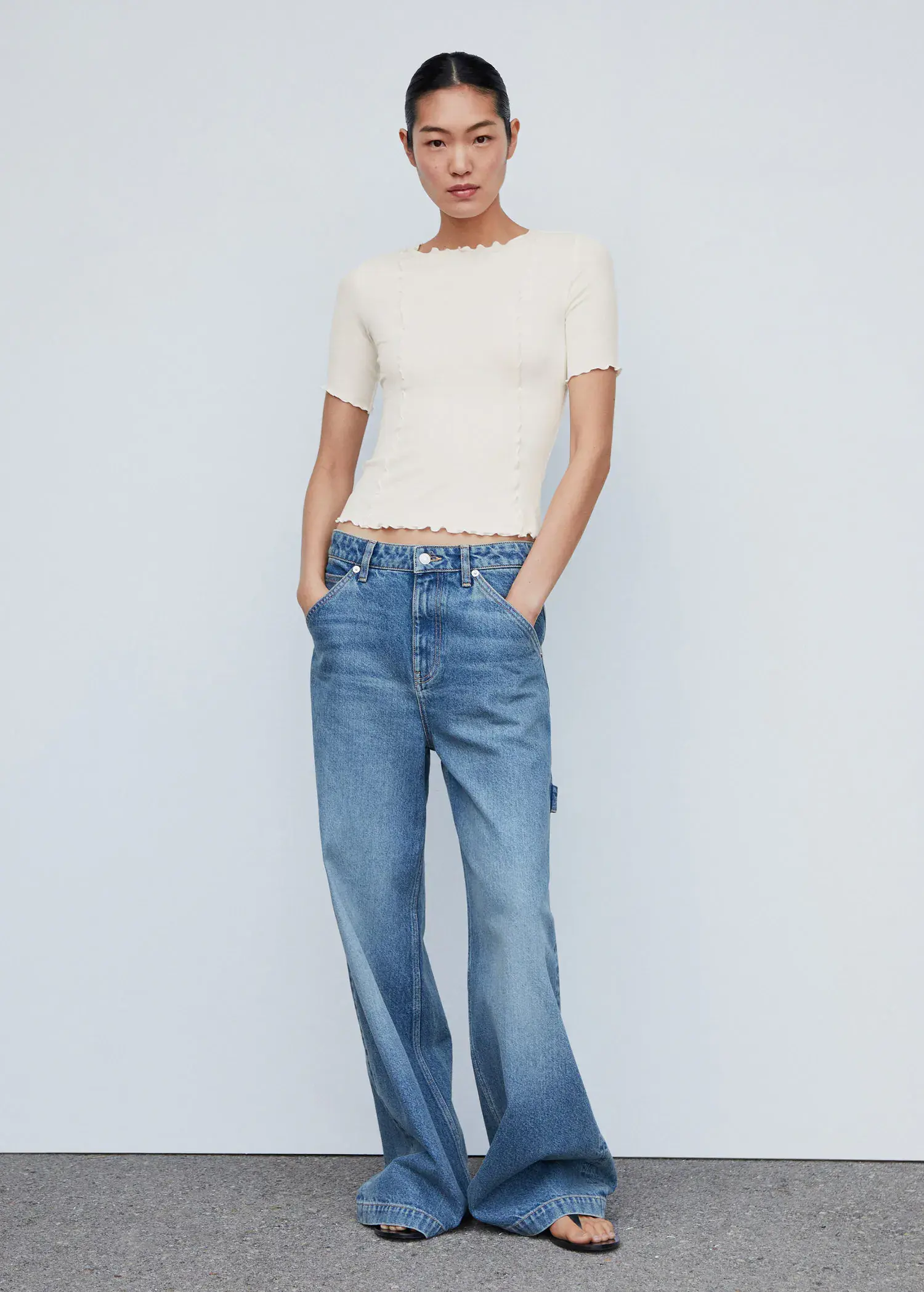 Mango Decorative seam T-shirt. a woman in white shirt and blue jeans. 