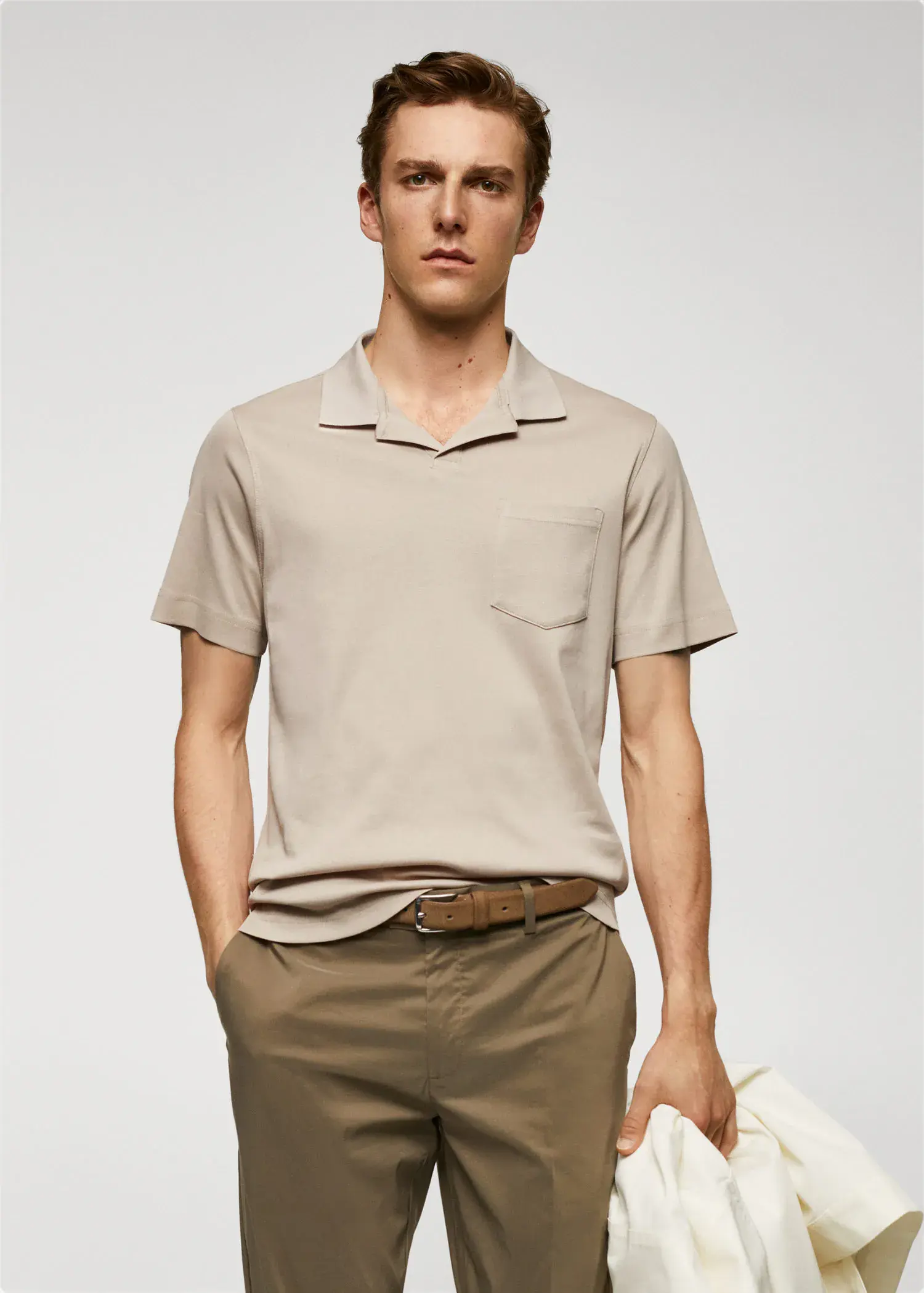 Mango 100% cotton polo shirt with pocket. a man in a tan polo shirt and brown pants. 