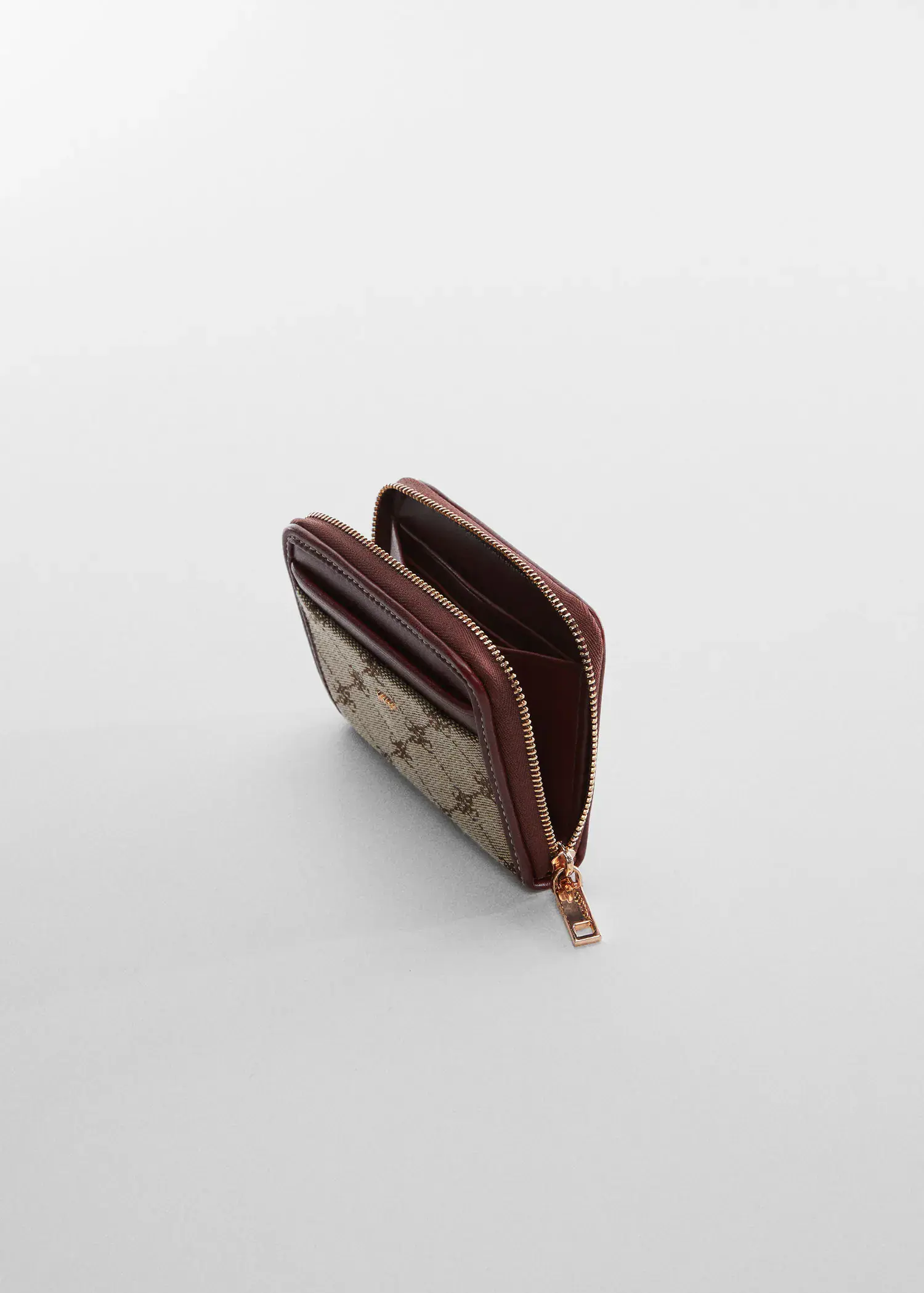 Mango Jacquard wallet. a brown wallet is sitting on the ground. 