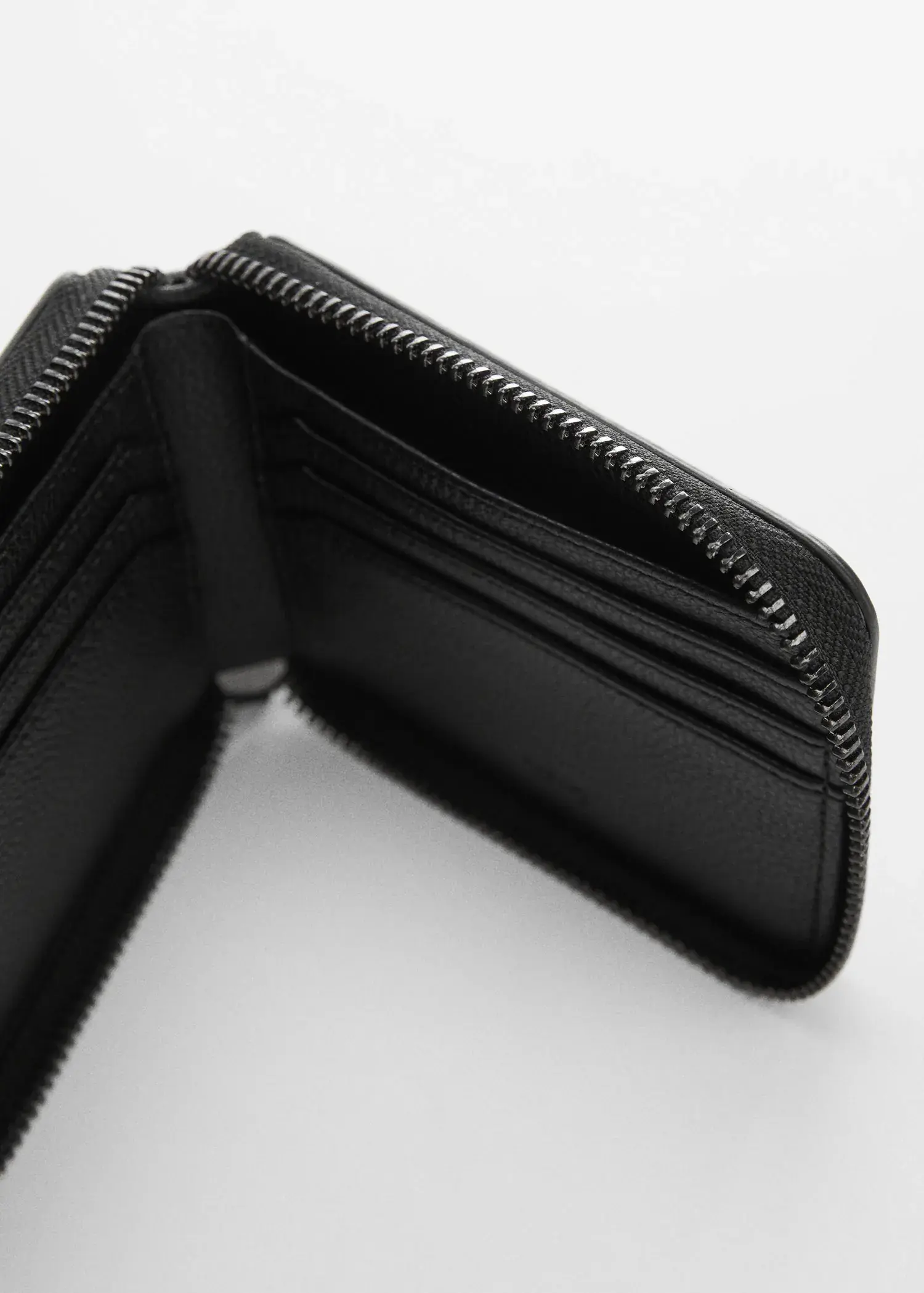 Mango Anti-contactless leather-effect card holder. a close-up of the inside of a black wallet. 