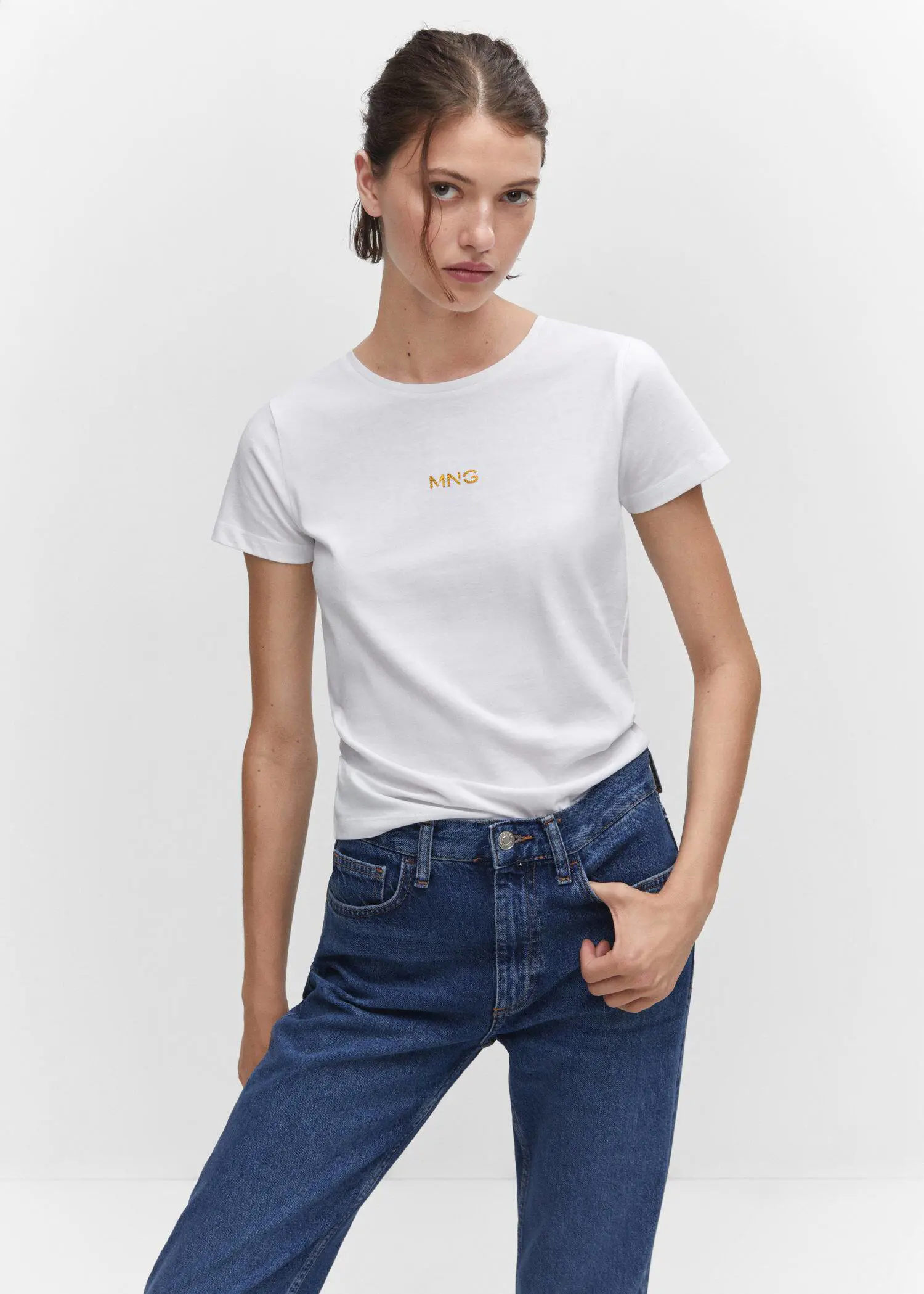 Mango Metallic logo T-shirt. a woman wearing a white t-shirt and blue jeans. 