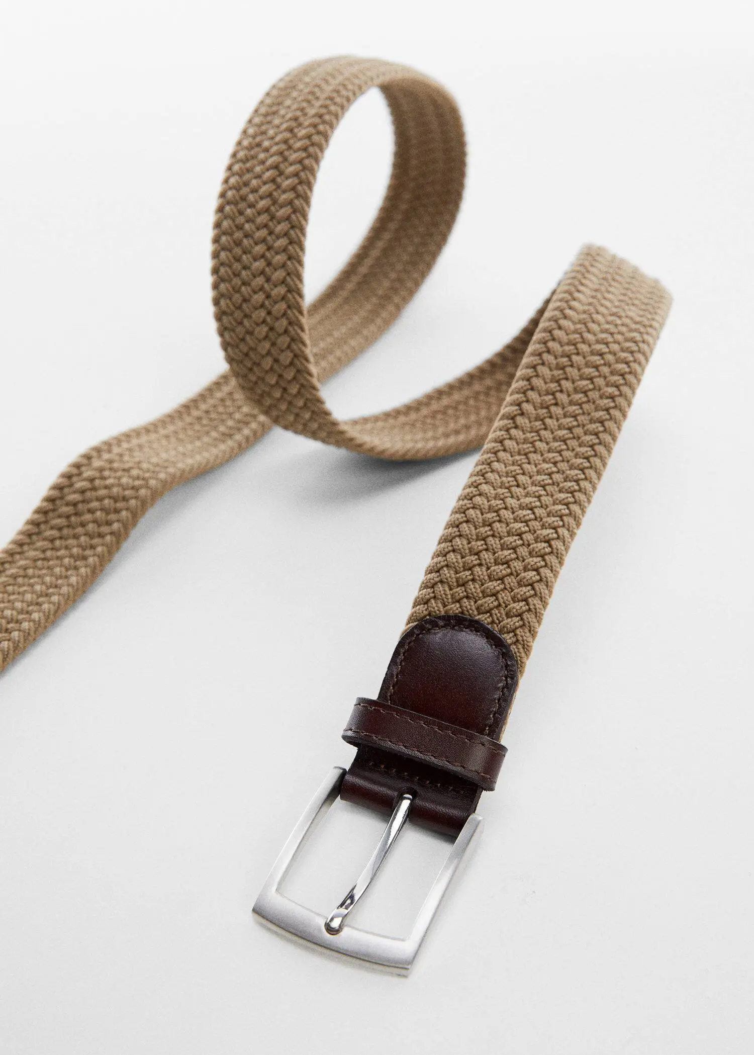Mango Braided elastic belt. a close-up of a brown belt on a white surface. 