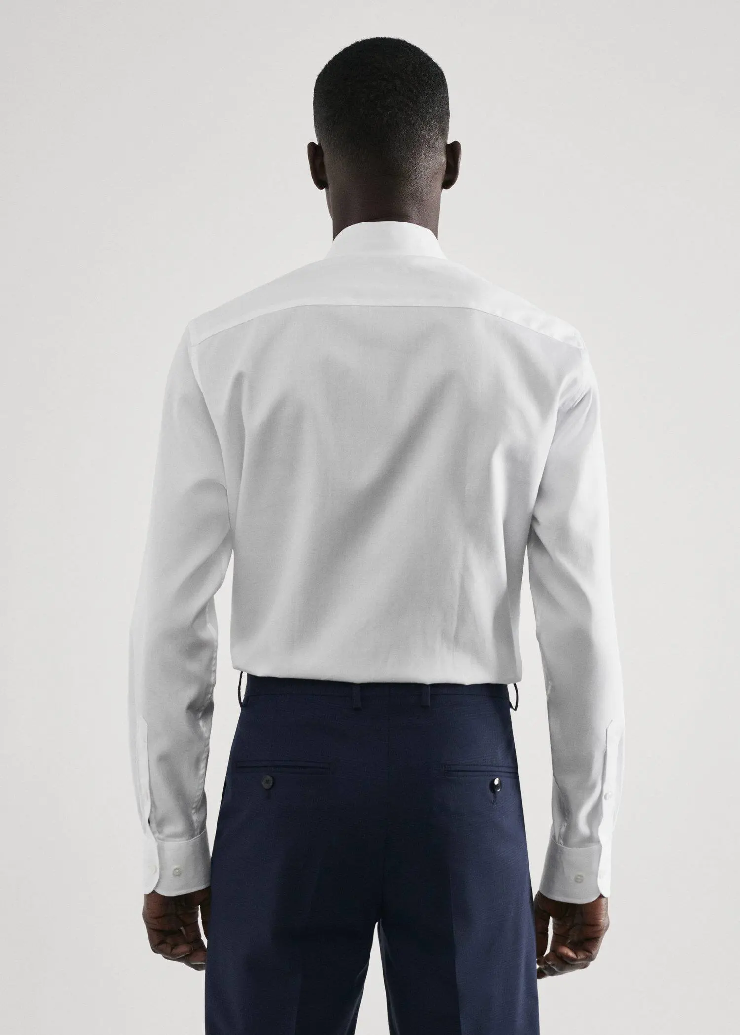 Mango Regular-fit structured suit shirt. a man wearing a white shirt and blue pants. 