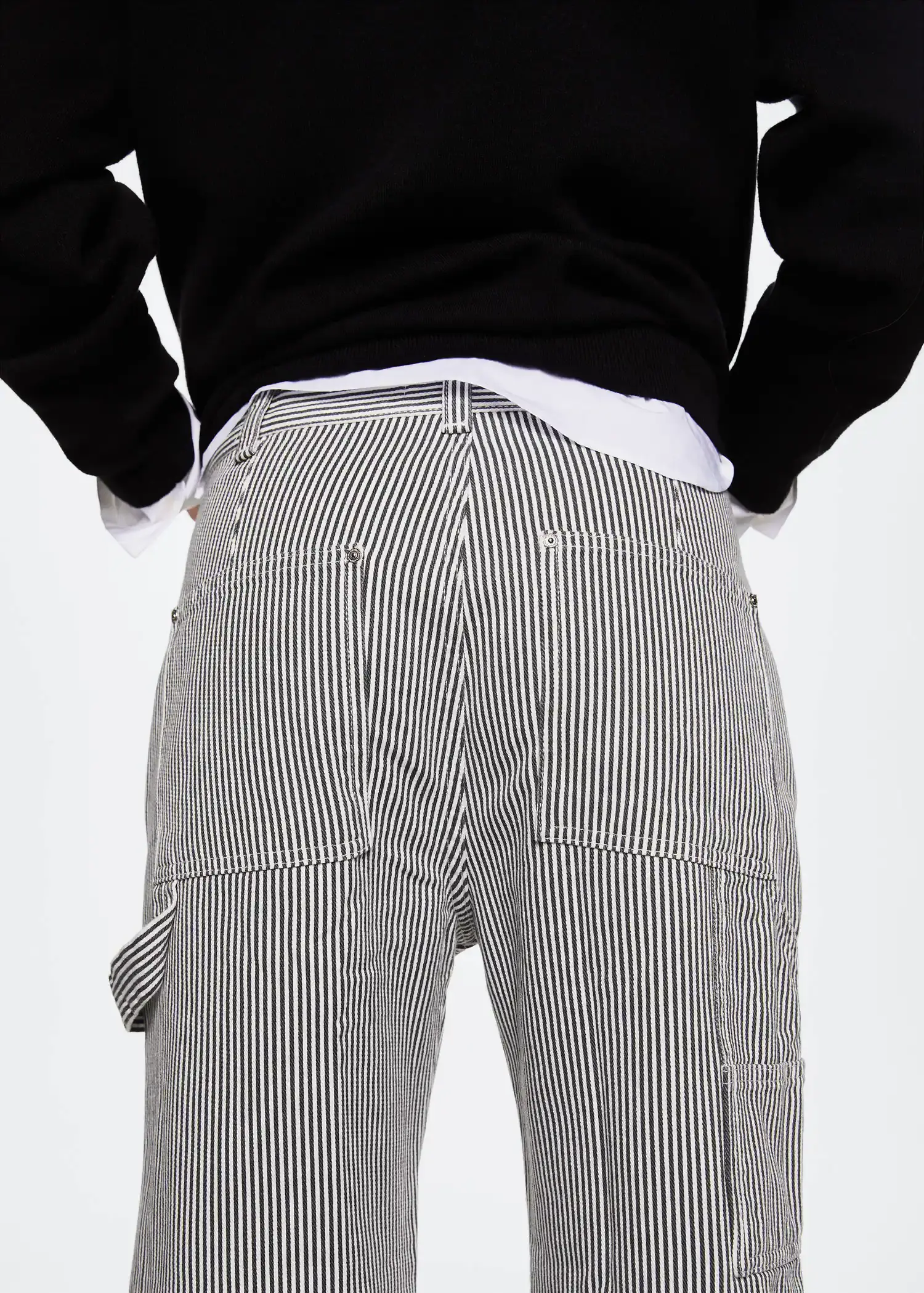 Mango Pocket cargo jeans. a person wearing a black and white striped shirt and pants. 
