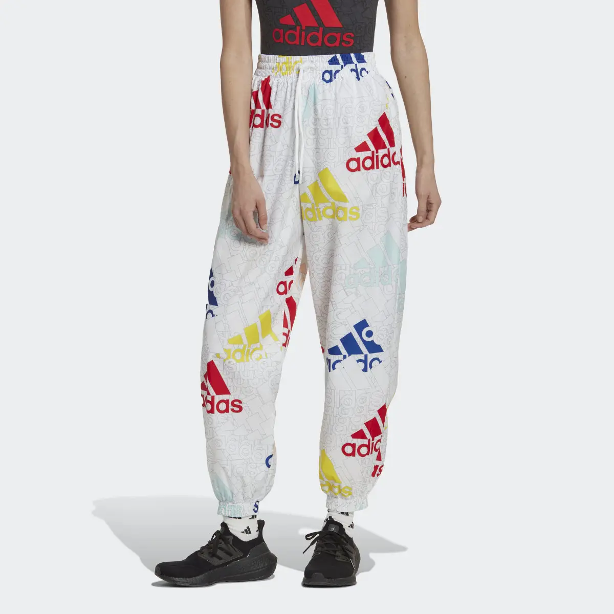 Adidas Essentials Multi-Colored Logo Loose Fit Woven Pants. 1