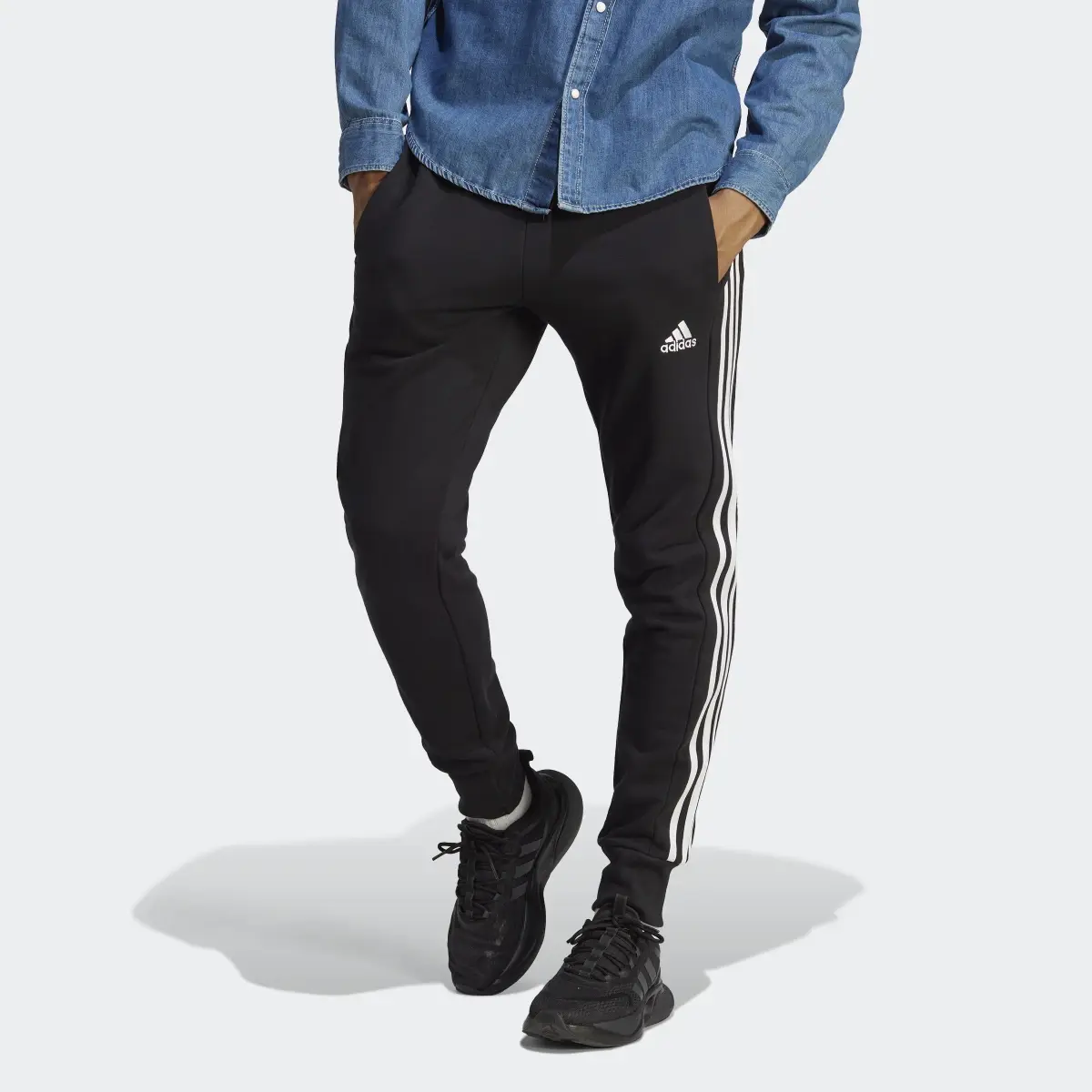 Adidas Pantaloni Essentials French Terry Tapered Cuff 3-Stripes. 1