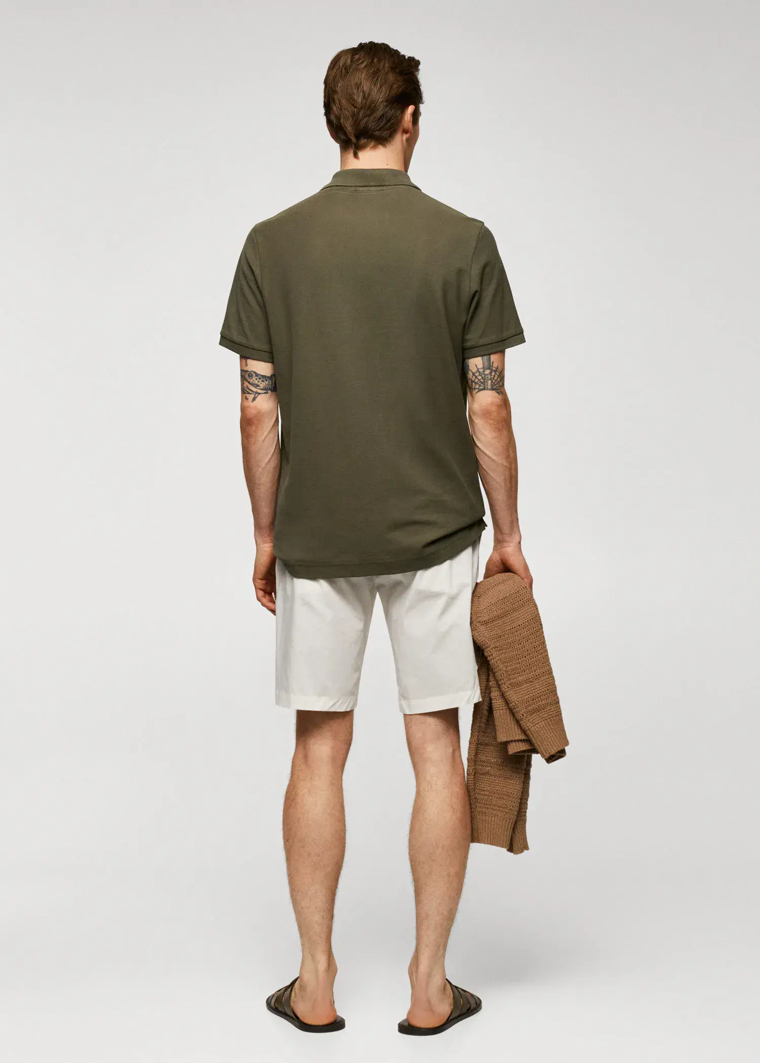 Mango 100% cotton pique polo shirt. a man in a green shirt and white shorts. 