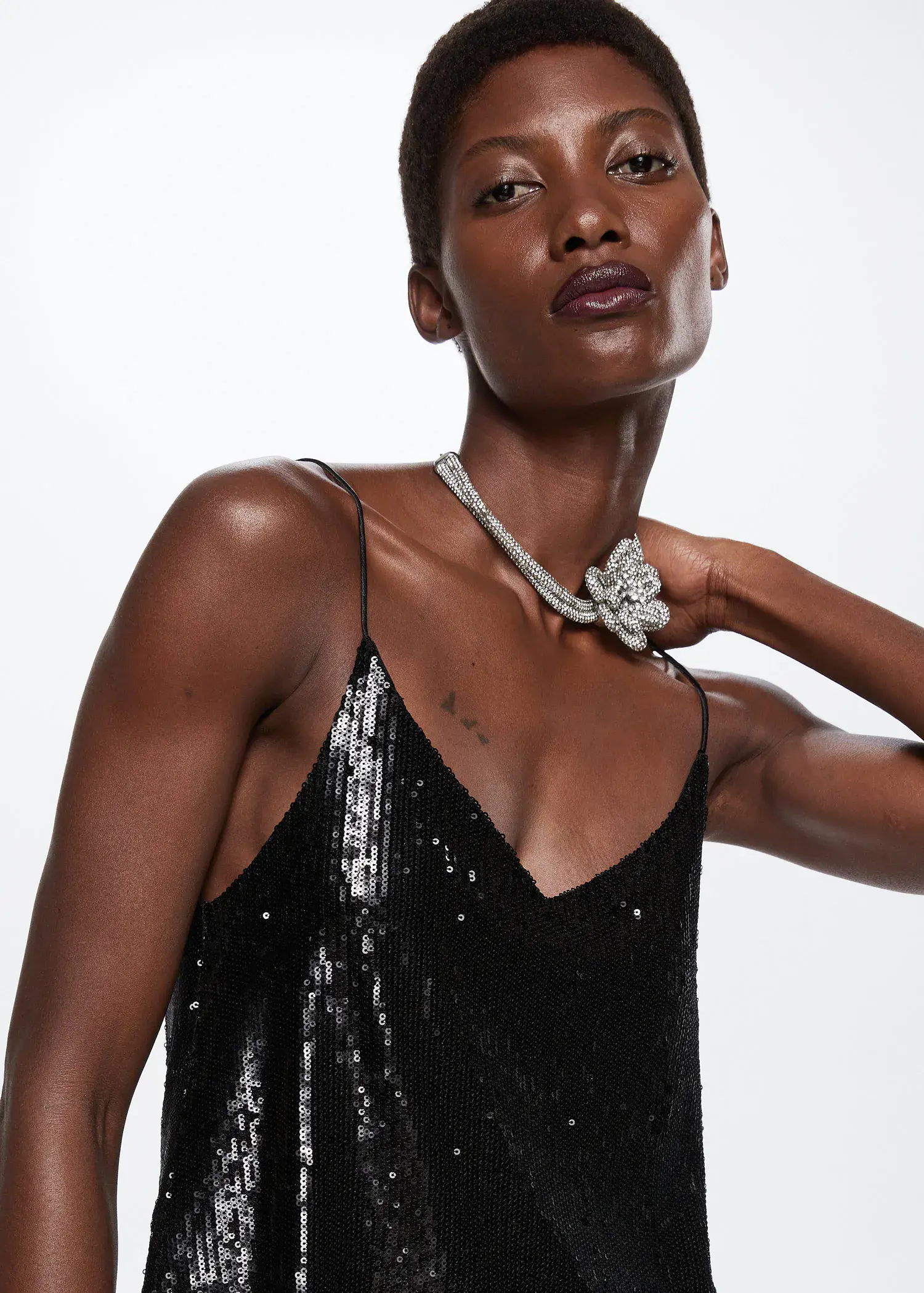 Mango Sequined strap top. a woman wearing a black dress and a necklace. 