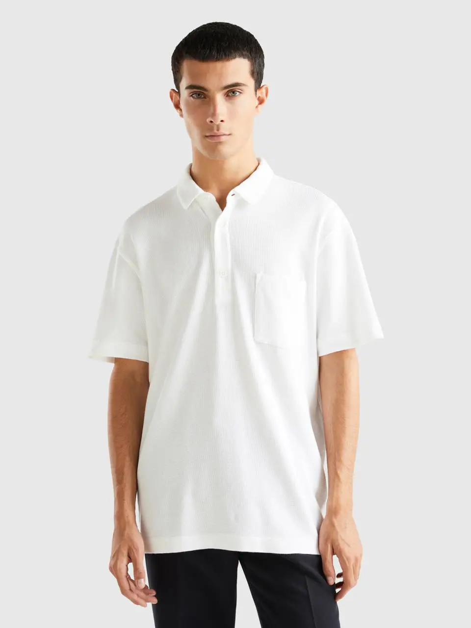 Benetton polo with pocket and relaxed fit. 1