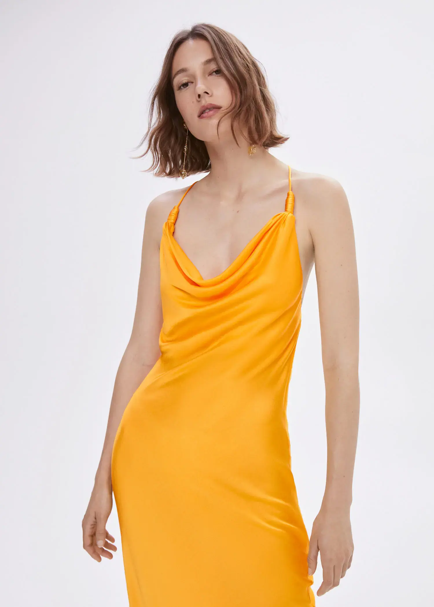 Mango Draped neck satin dress. a woman in a yellow dress posing for a picture. 