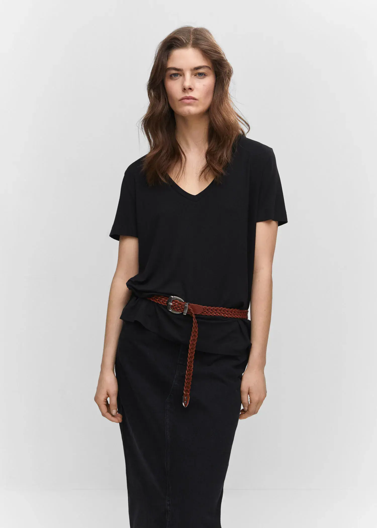 Mango V-neck T-shirt. a woman wearing a black dress and a brown belt. 