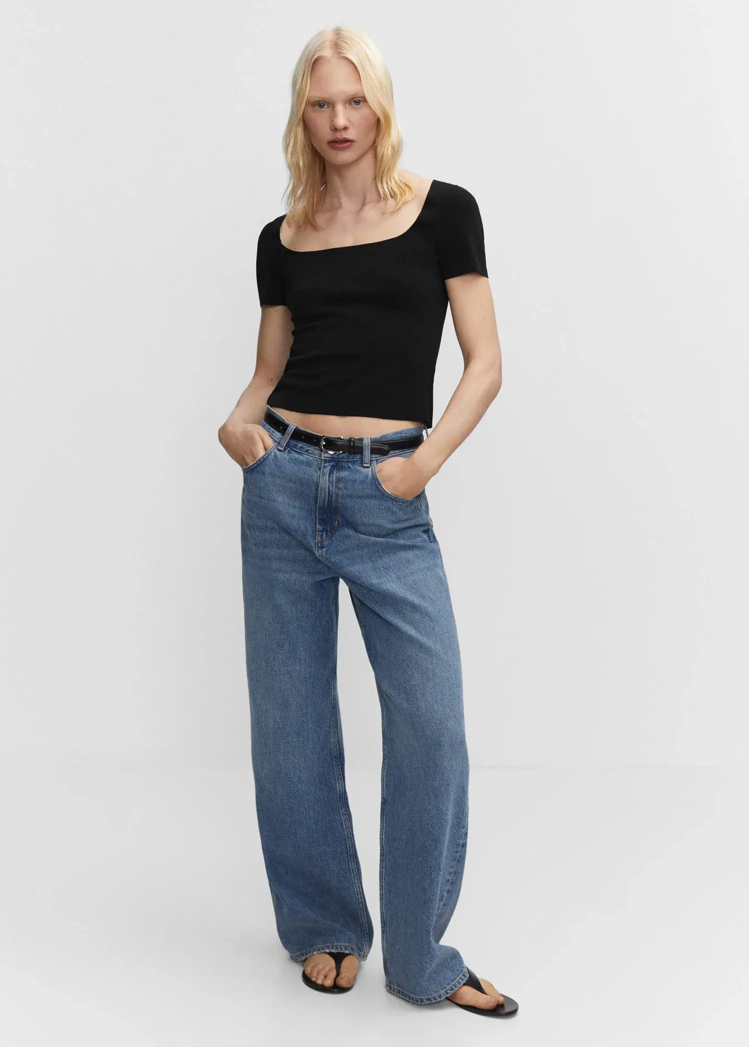 Mango Square neck t-shirt. a woman in black shirt and blue jeans. 