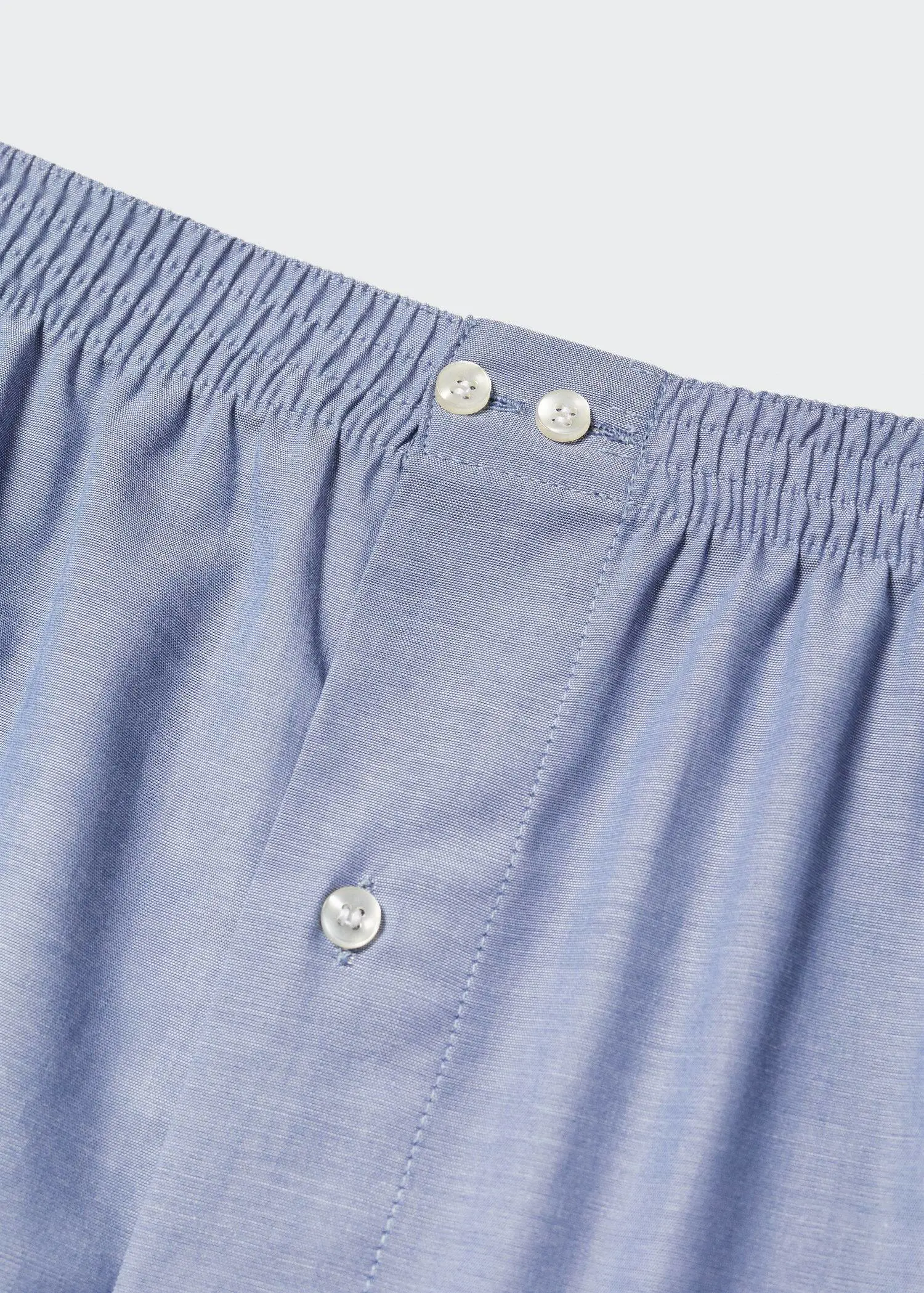 Mango 100% cotton plain briefs. a close up view of the buttons on a pair of boxers. 