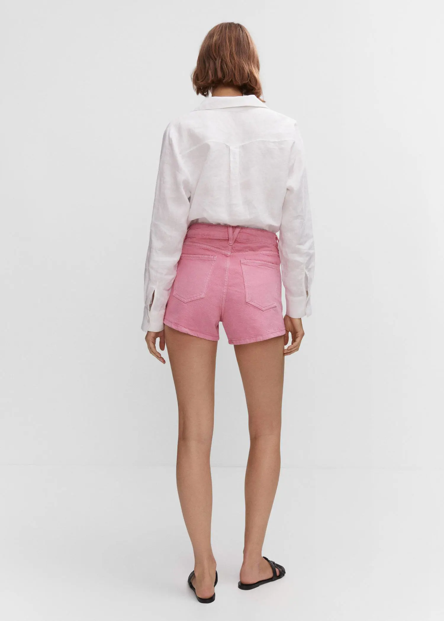 Mango Denim shorts with buttons. a person wearing pink shorts and a white shirt. 