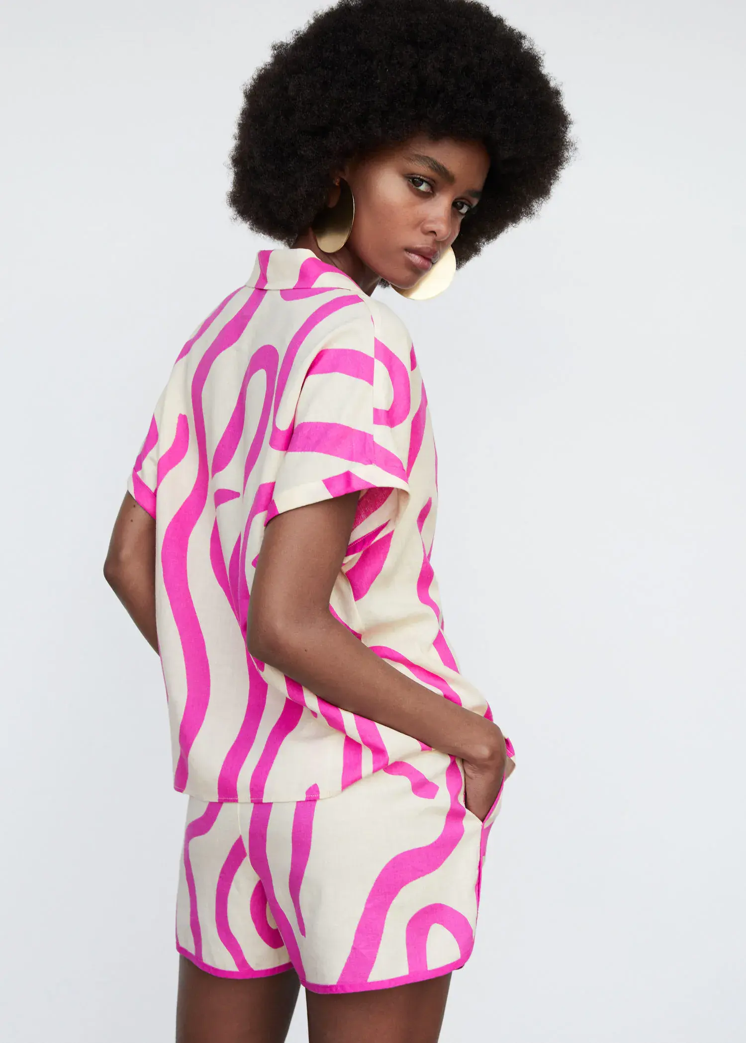 Mango Printed linen shirt. a woman wearing a pink and white outfit. 